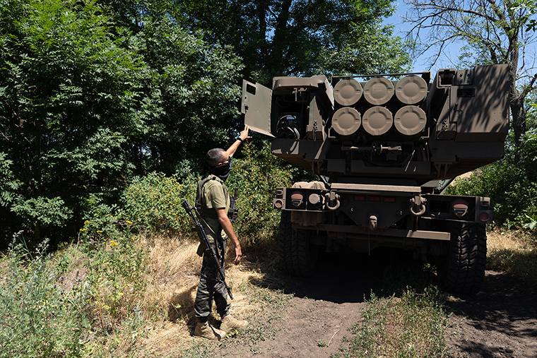 The commander of an Ukranian unit shows the rockets on HIMARS vehicle in Eastern Ukraine on July 1.
