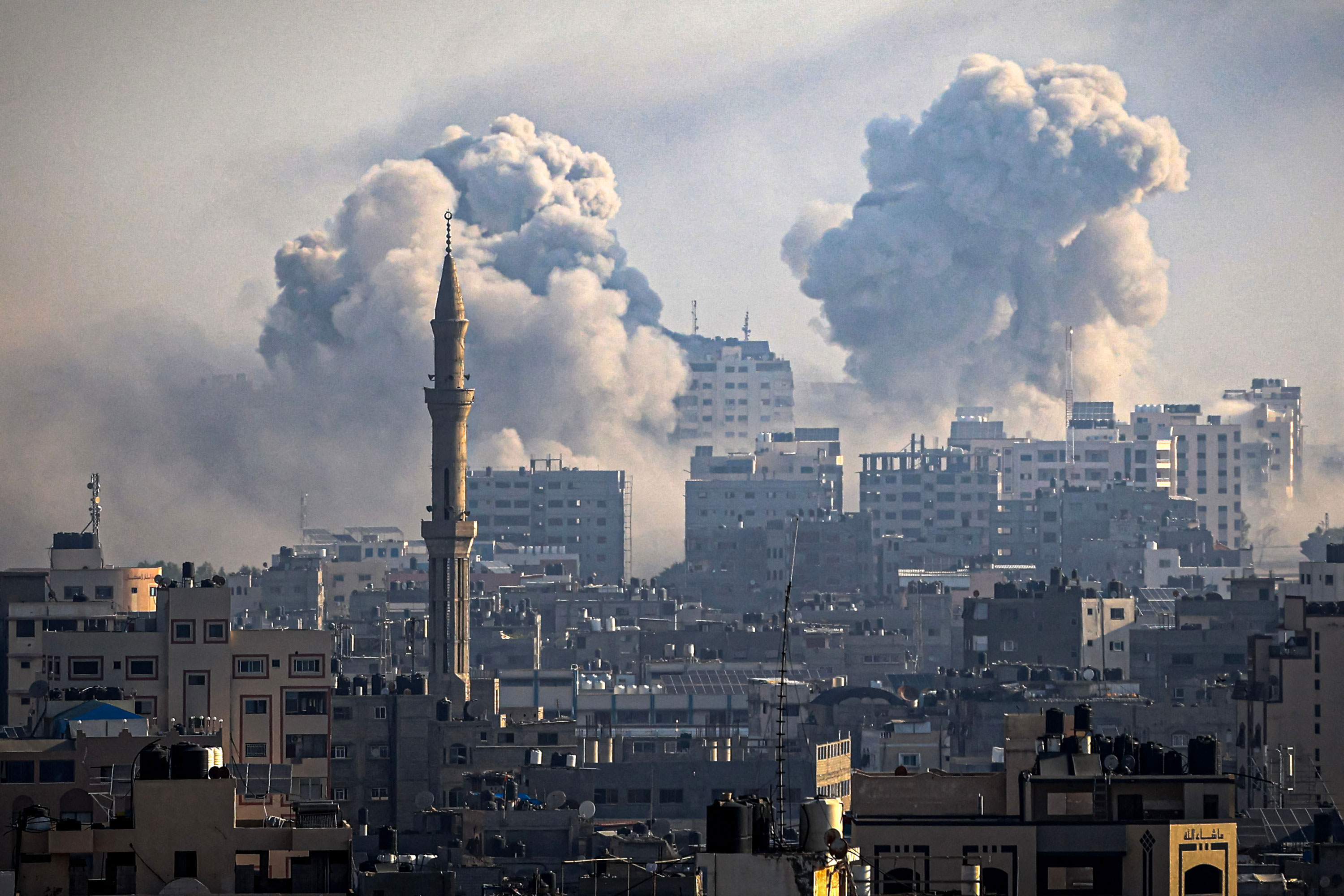 Smoke plumes billow during Israeli airstrikes in Gaza City on October 12, 2023.