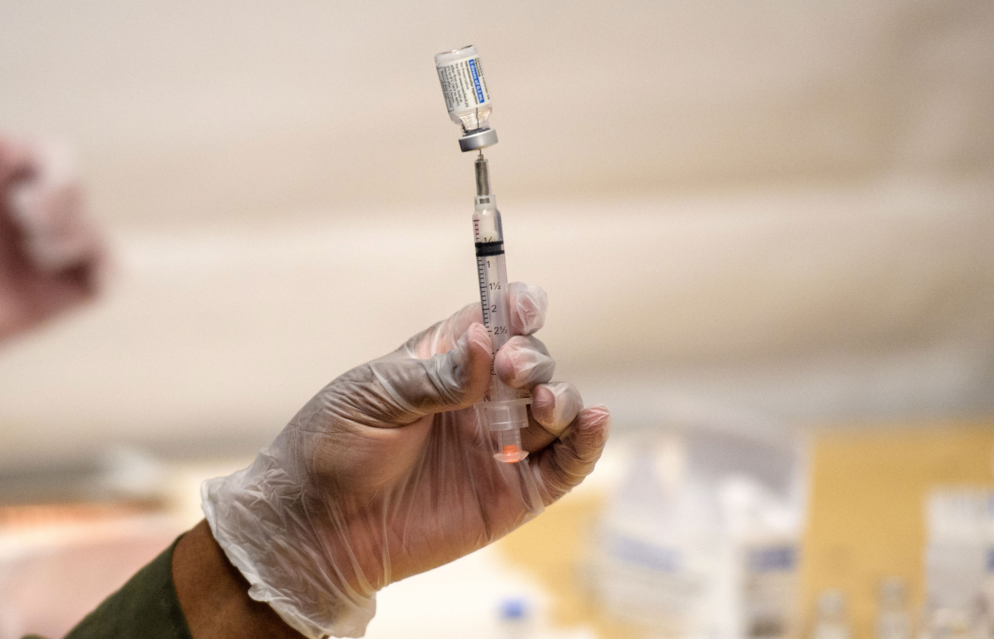 A health care worker prepares a Johnson & Johnson Covid-19 vaccine on May 12 in New York.