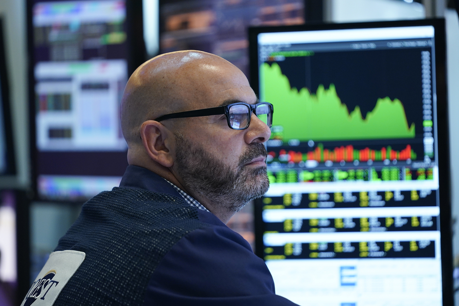 As the Federal Reserve announces a rate change, a trader works on the floor at the New York Stock Exchange in New York, on Wednesday, June 15.