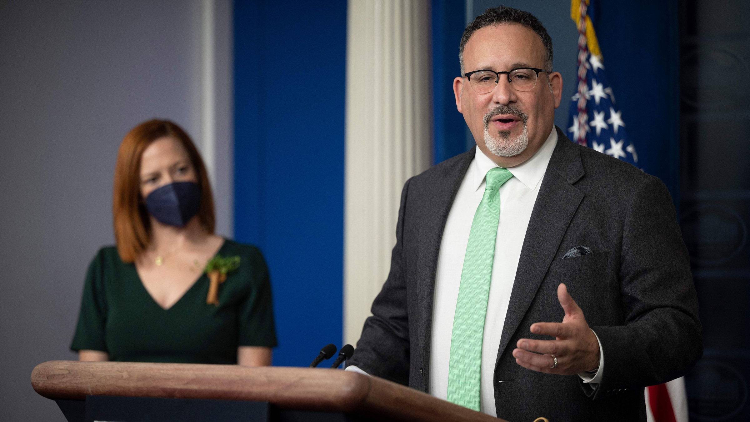 Education Secretary Miguel Cardona, flanked by White House press secretary Jen Psaki, speaks during the daily press briefing at the White House on Wednesday.