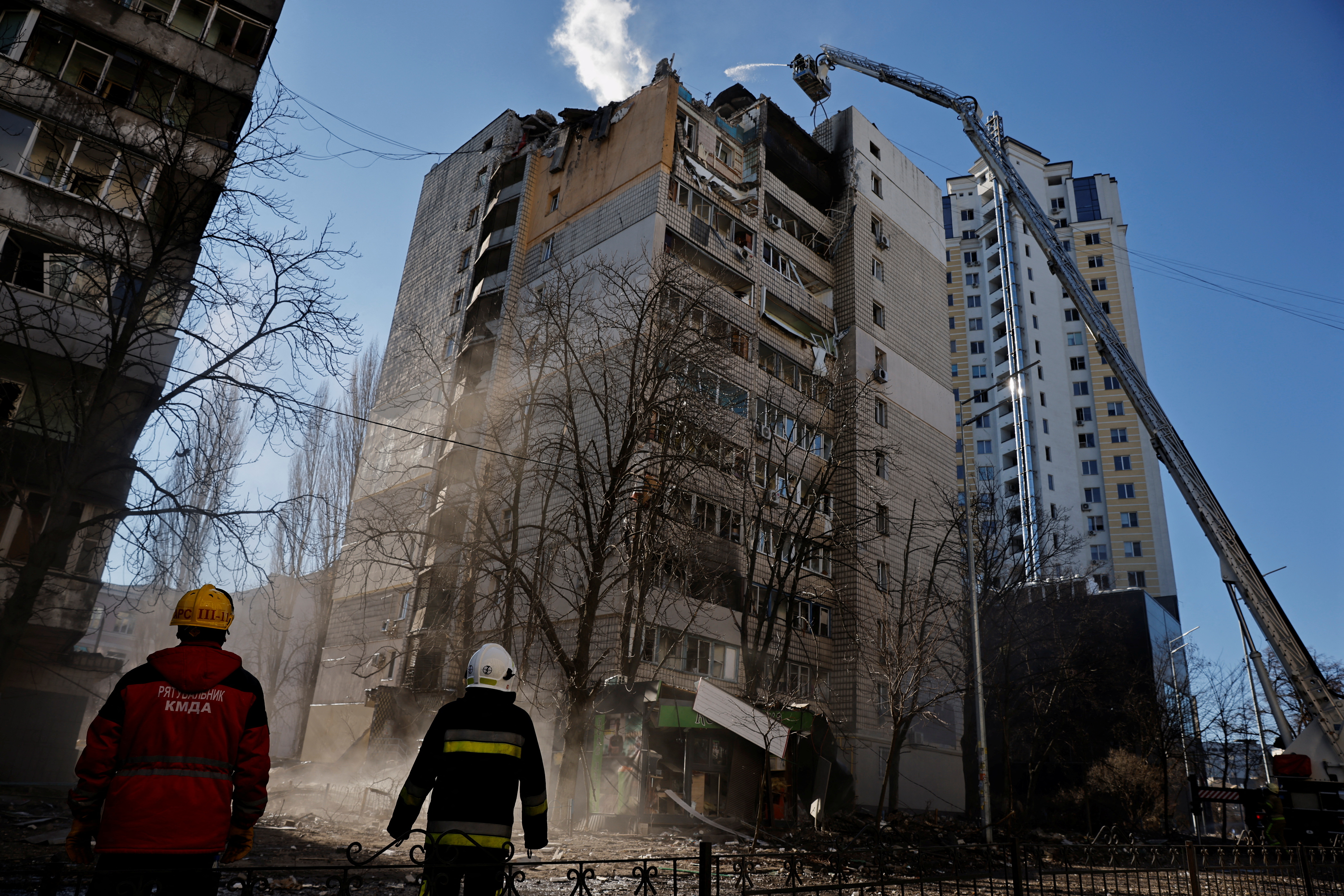 Rescuers work next to an apartment building that was hit by shelling in Kyiv, Ukraine, on March 16.