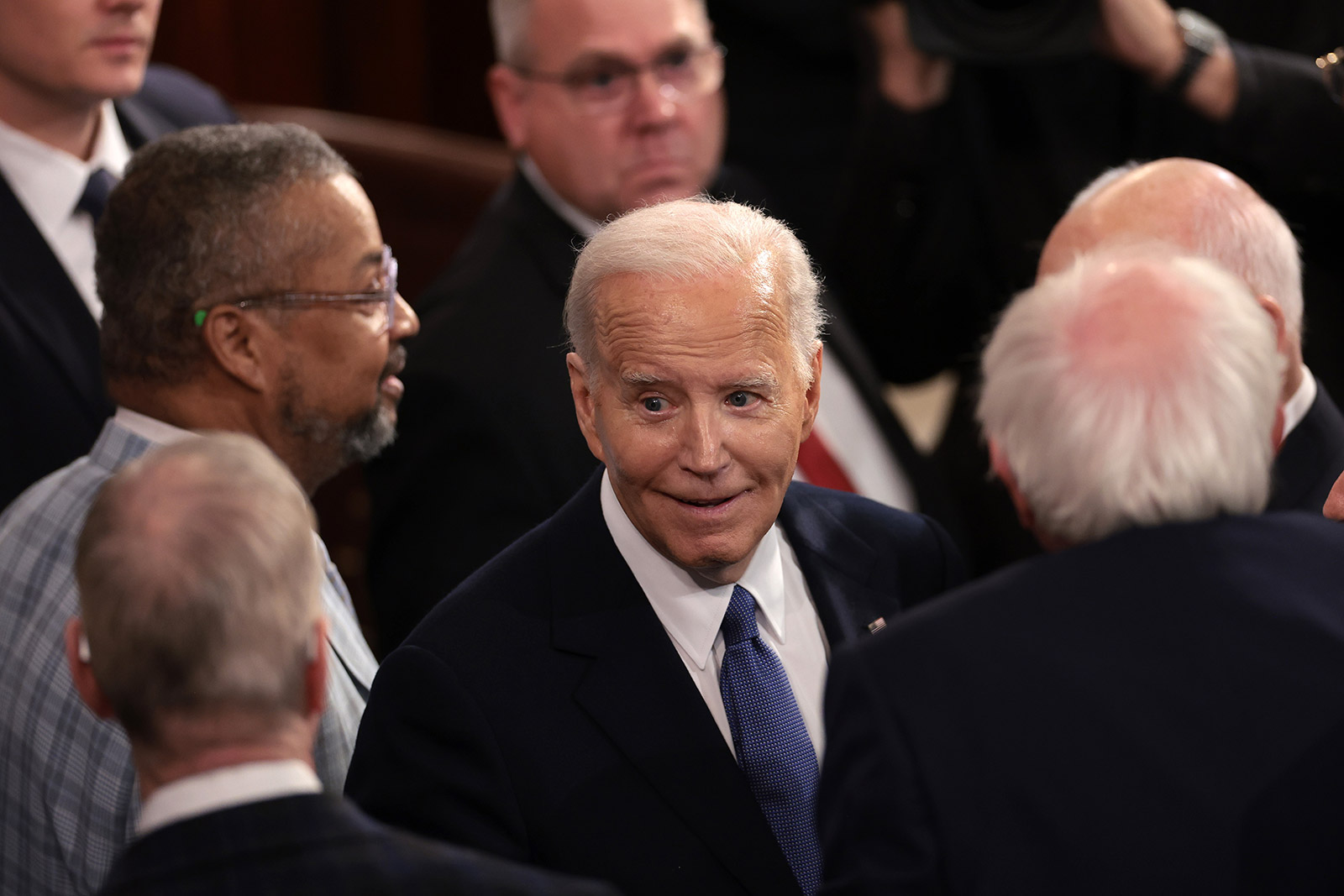 Biden greets members of Congress after his speech.
