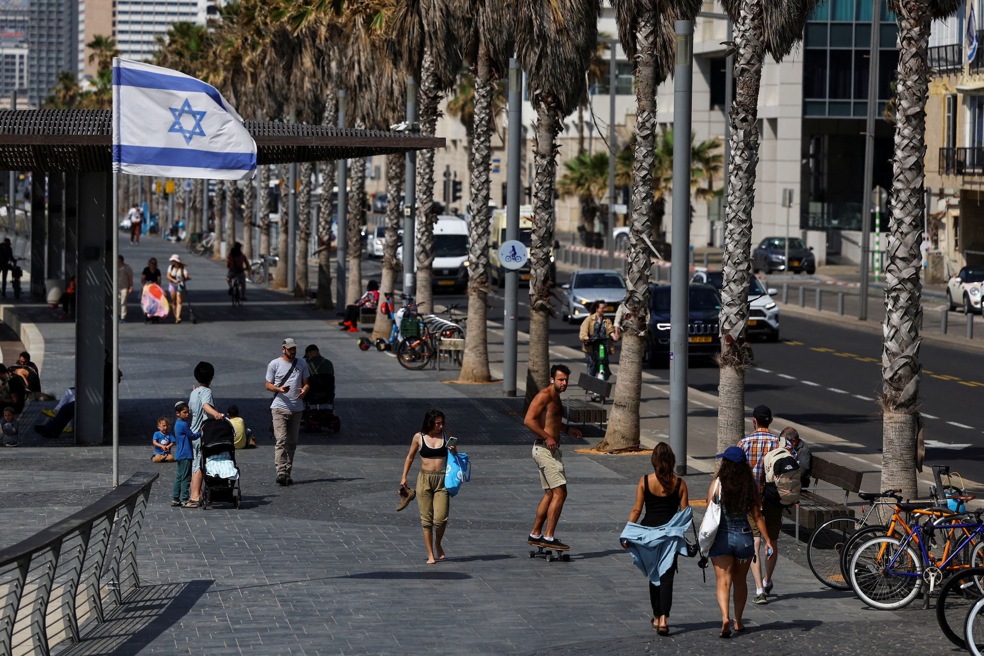 People walk down a street in Tel Aviv on Saturday.