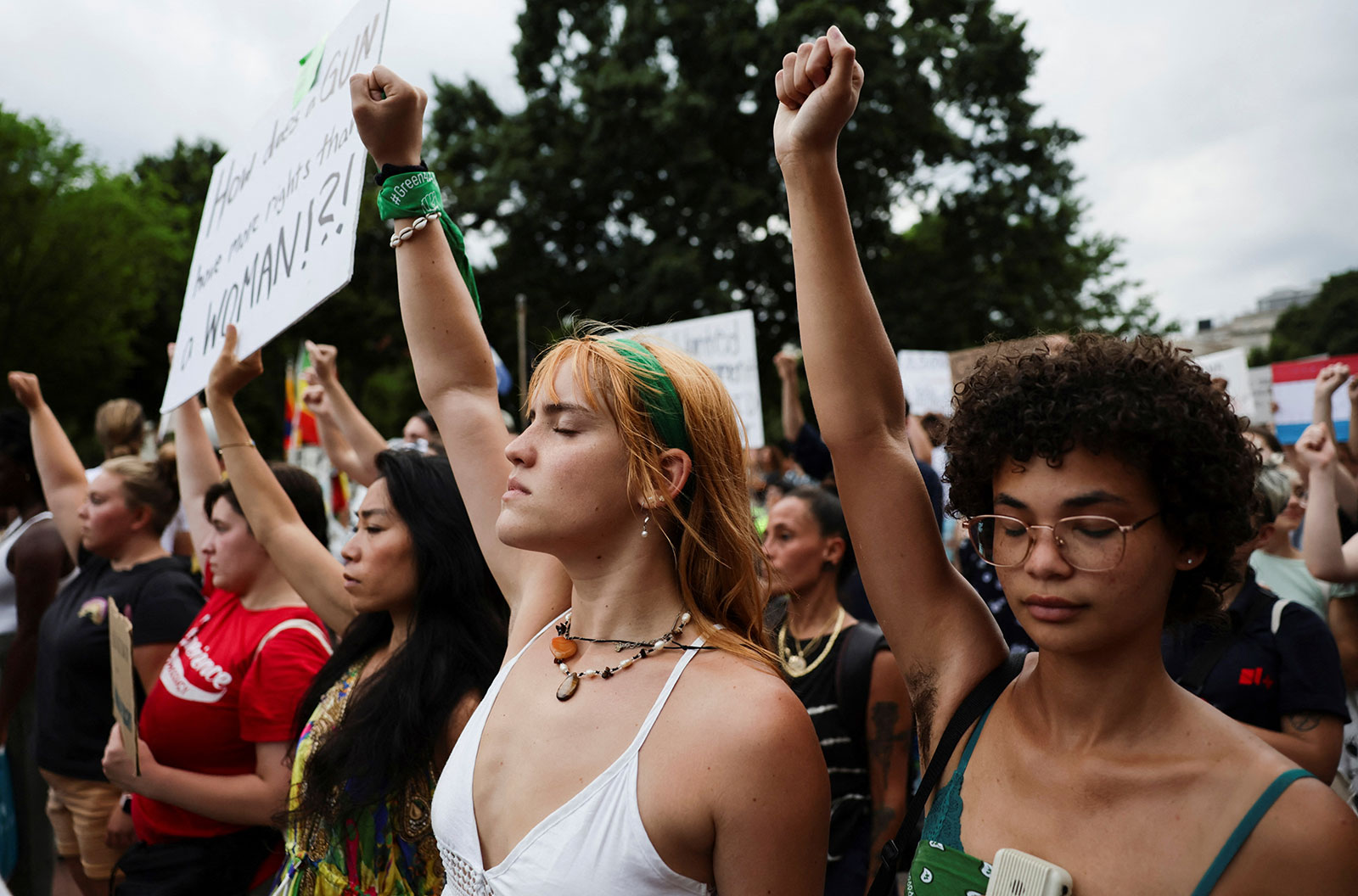 Abortion rights supporters raise their fists during a moment of silence as they protest in Washington, DC, on June 26. 