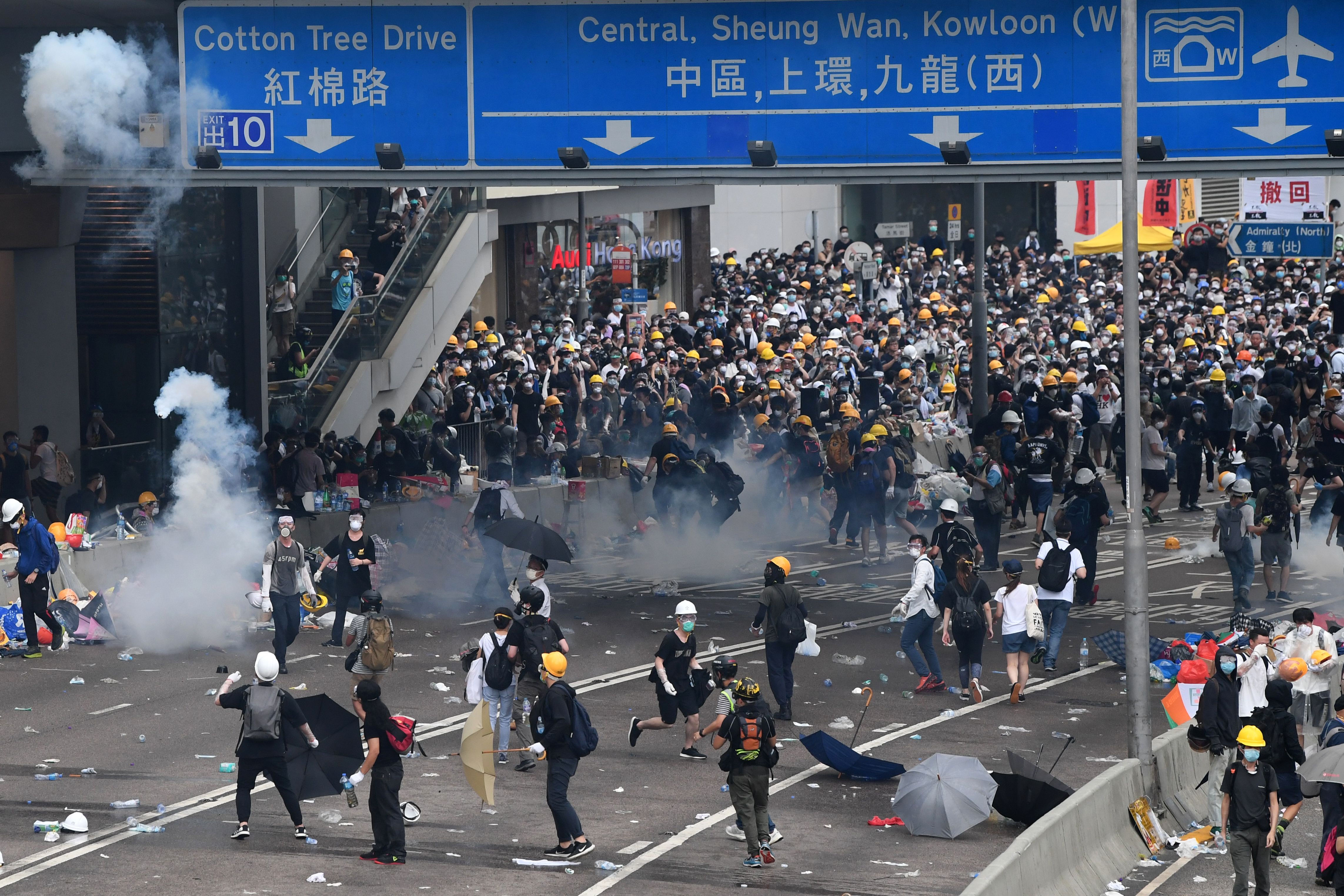 Protesters react after police fired tear gas during a rally against a controversial extradition law proposal outside the government headquarters in Hong Kong on Wednesday. 