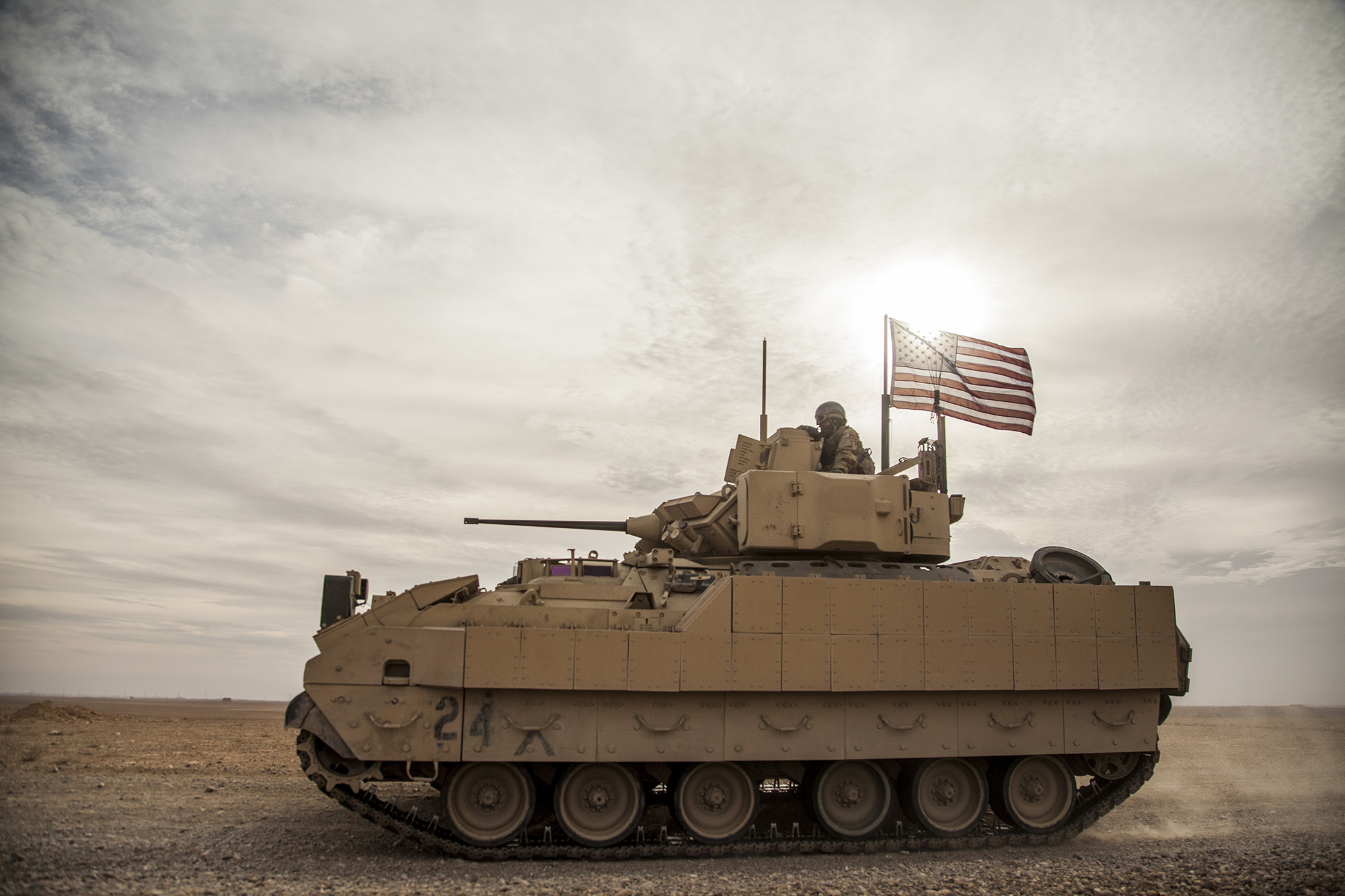 American soldiers drive a Bradley fighting vehicle during a joint exercise with Syrian Democratic Forces in Deir Ezzor in northeastern Syria, on December 8, 2021.