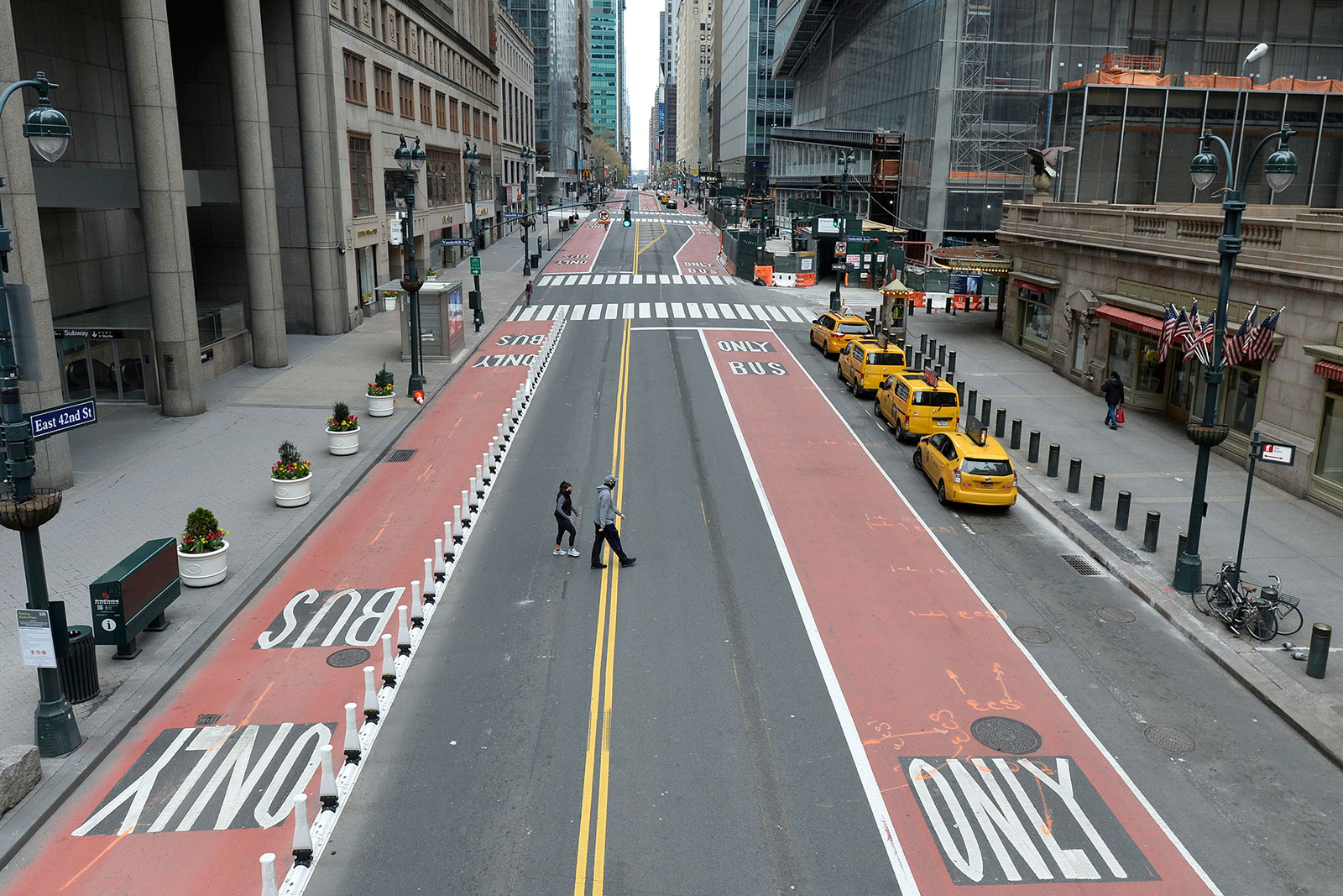 Pedestrians cross 42nd Street in Manhattan, New York, on April 12.