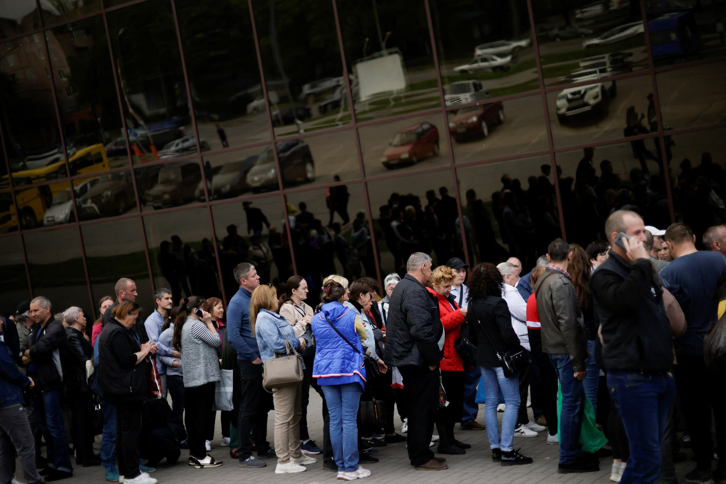 Ukrainian evacuees queue for aid at a donation collection point,in Zaporizhzhia, on May 4,