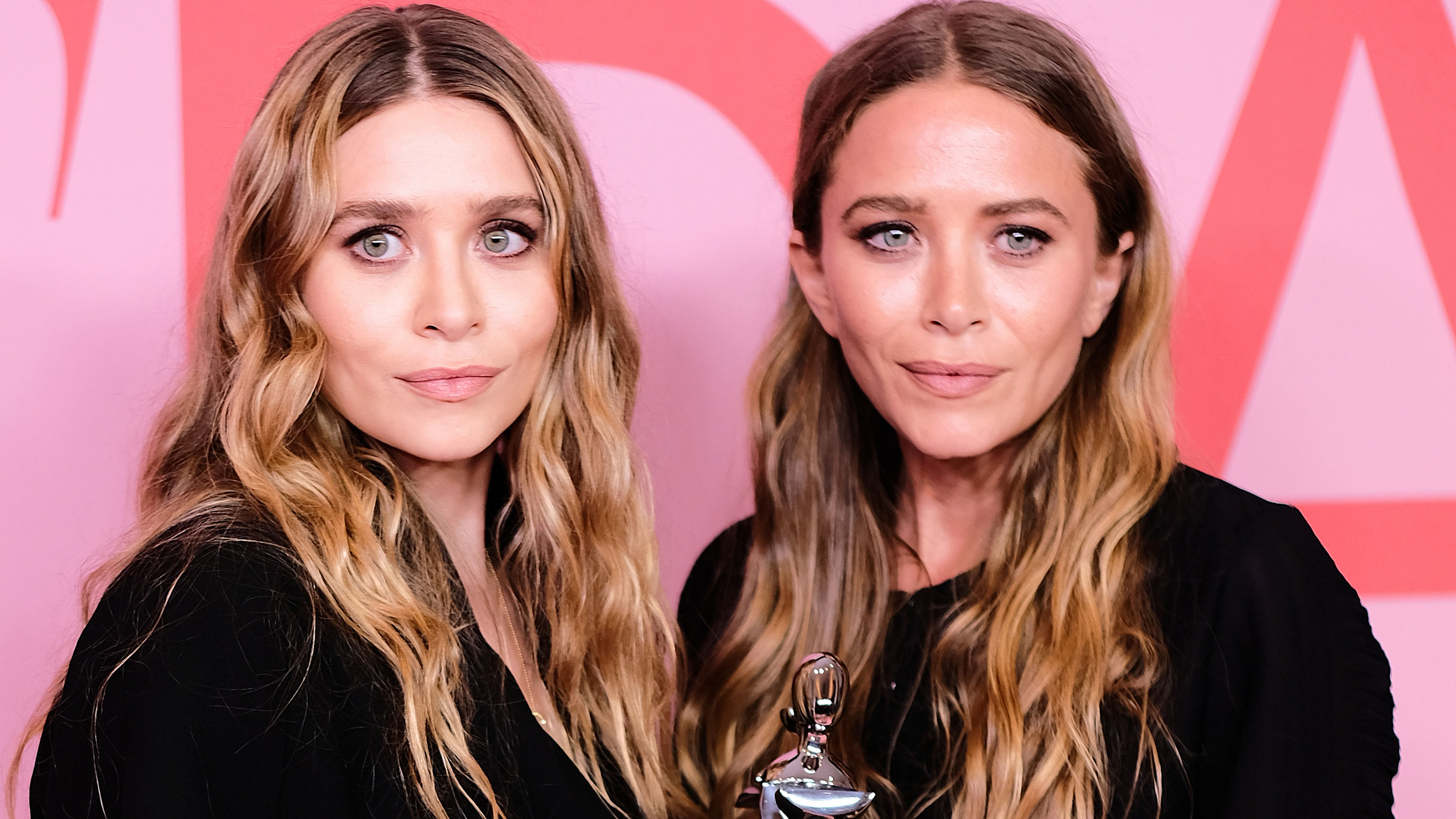 Ashley Olsen, left, and Mary-Kate Olsen pose for photos in 2019.