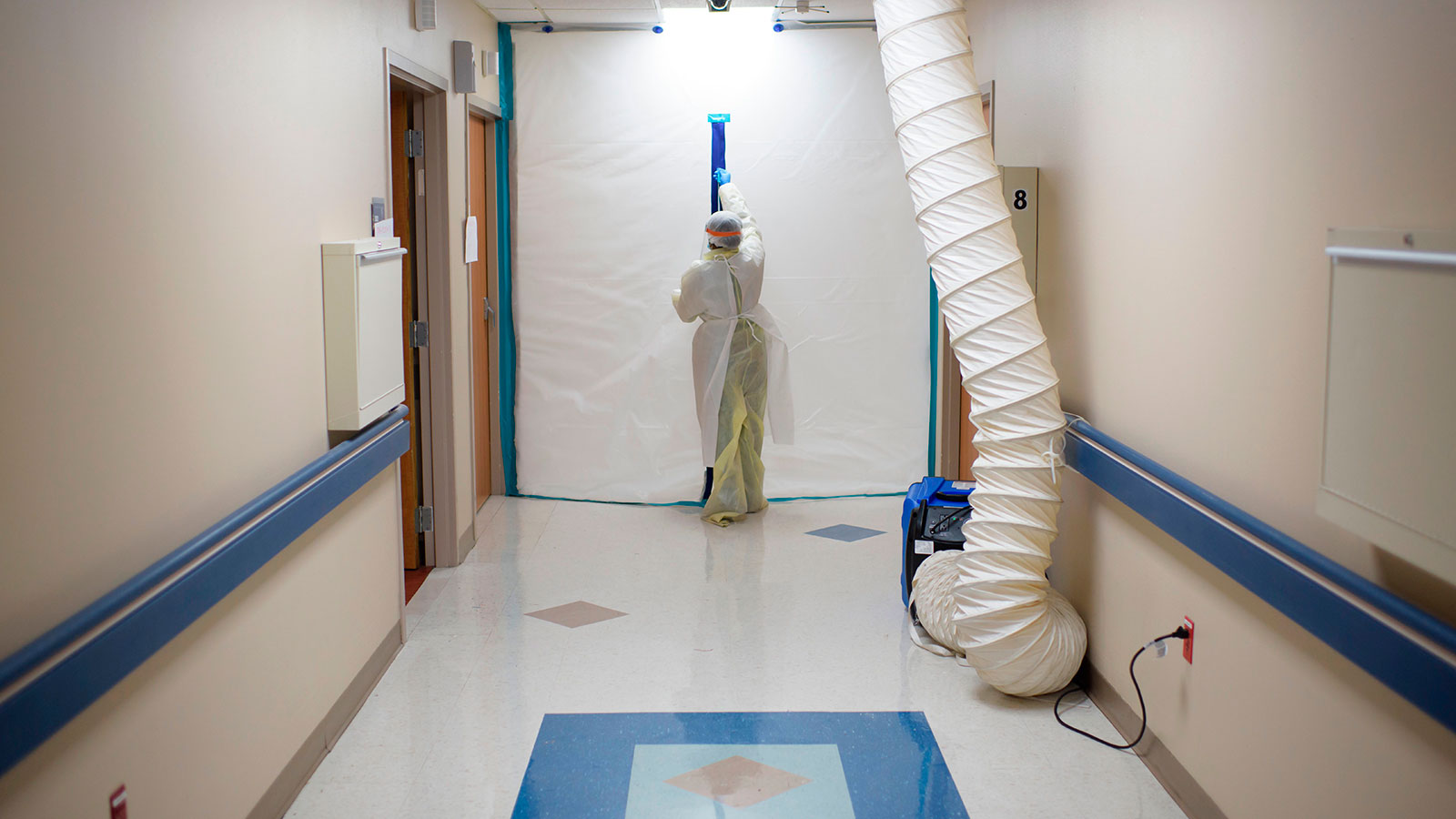 A healthcare worker zips up a protective barrier in the Covid-19 Unit at United Memorial Medical Center in Houston, Texas on July 2.