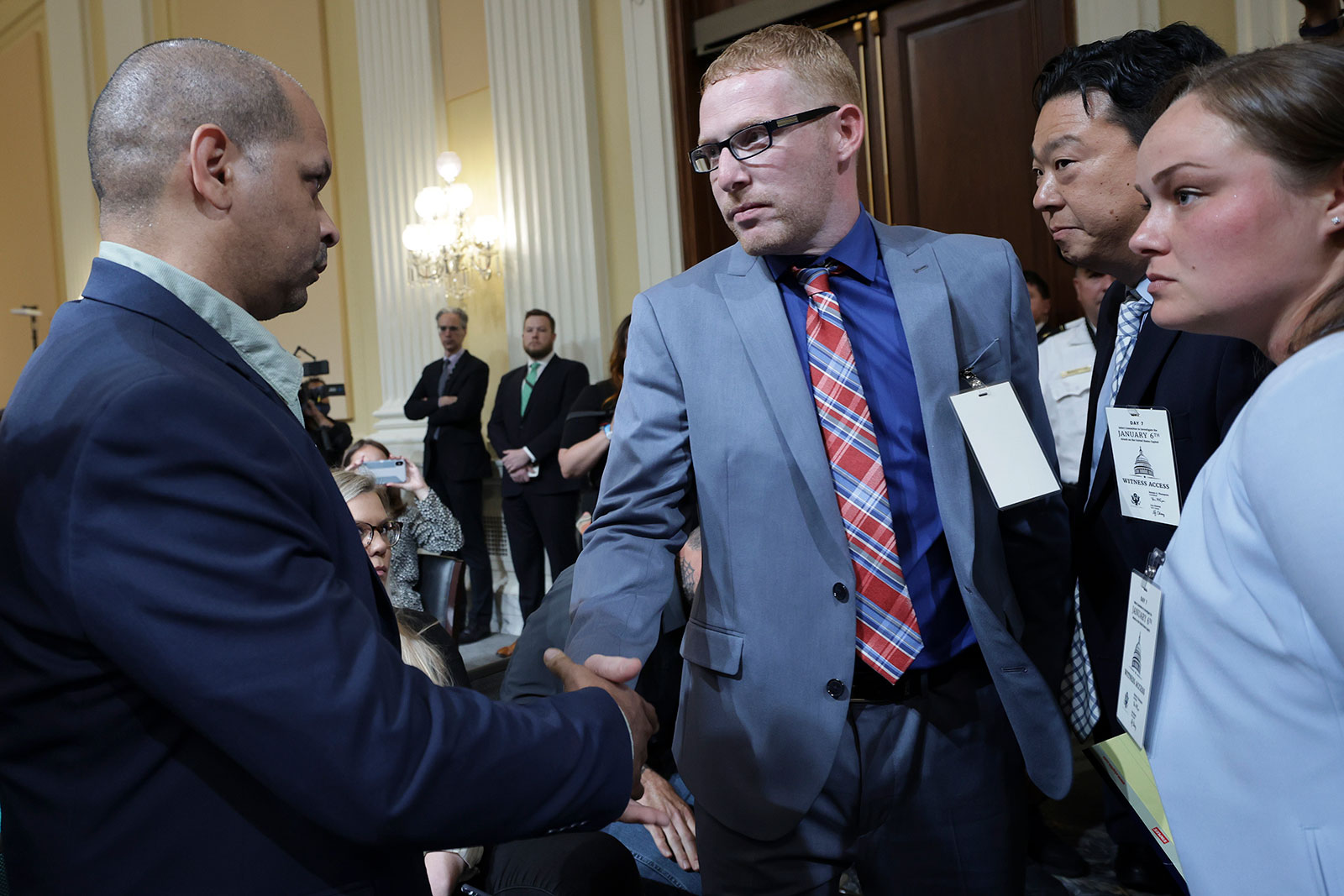 Stephen Ayres, third from right, shakes hands with US Capitol Police Sgt. Aquilino Gonell, left, after the House select committee hearing on July 12. 