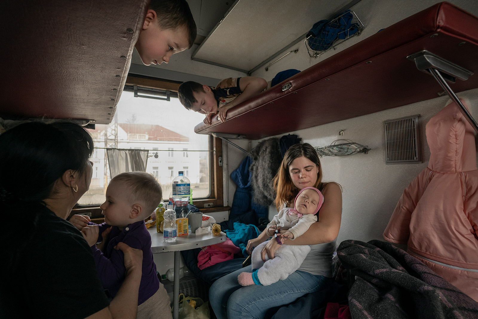 Inside an evacuation train, families travel in a carriage reserved for children with special needs. They were heading to Chop, a Ukrainian city near the Polish border.