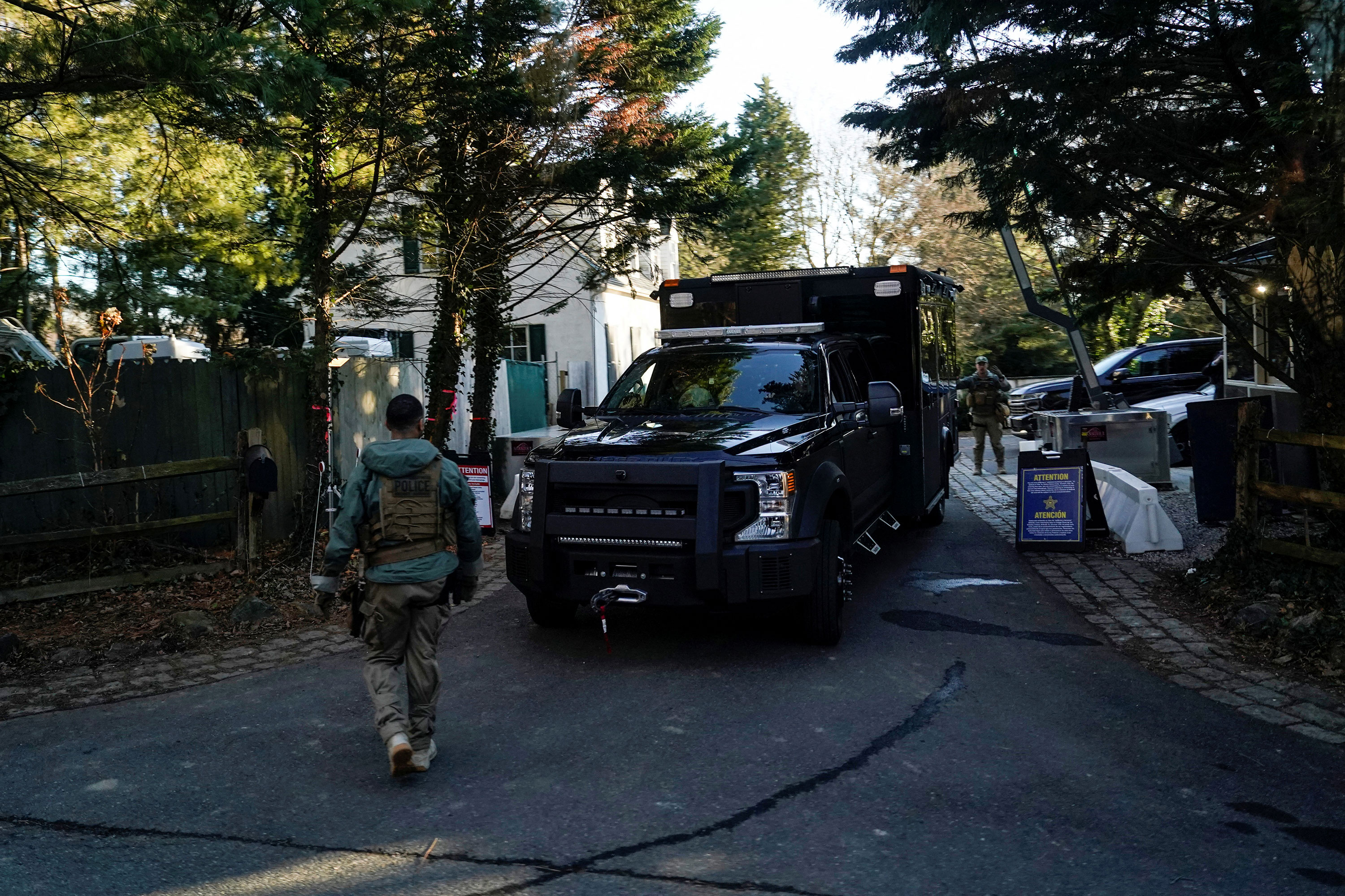 Secret Service personnel park vehicles in the driveway leading to Joe Biden's Wilmington, Delaware, home after classified documents were reported found there by the White House on January 15, 2023. 