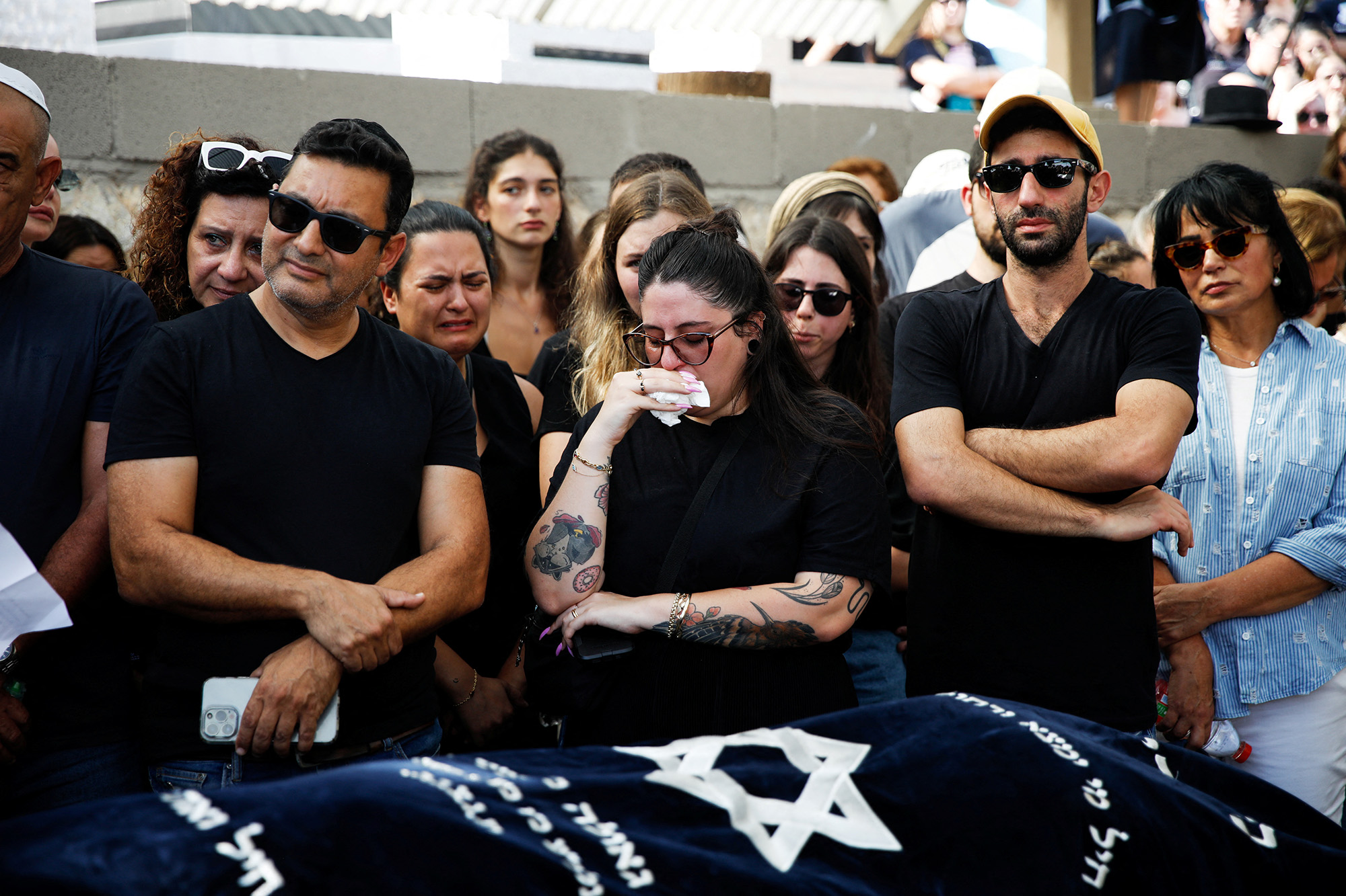 Family and friends mourn Danielle, 25, and Noam, 26, an Israeli couple who were killed in a deadly attack as they attended a festival, as they are buried next to each other at their funeral in Kiryat Tivon, Israel, on October 12.
