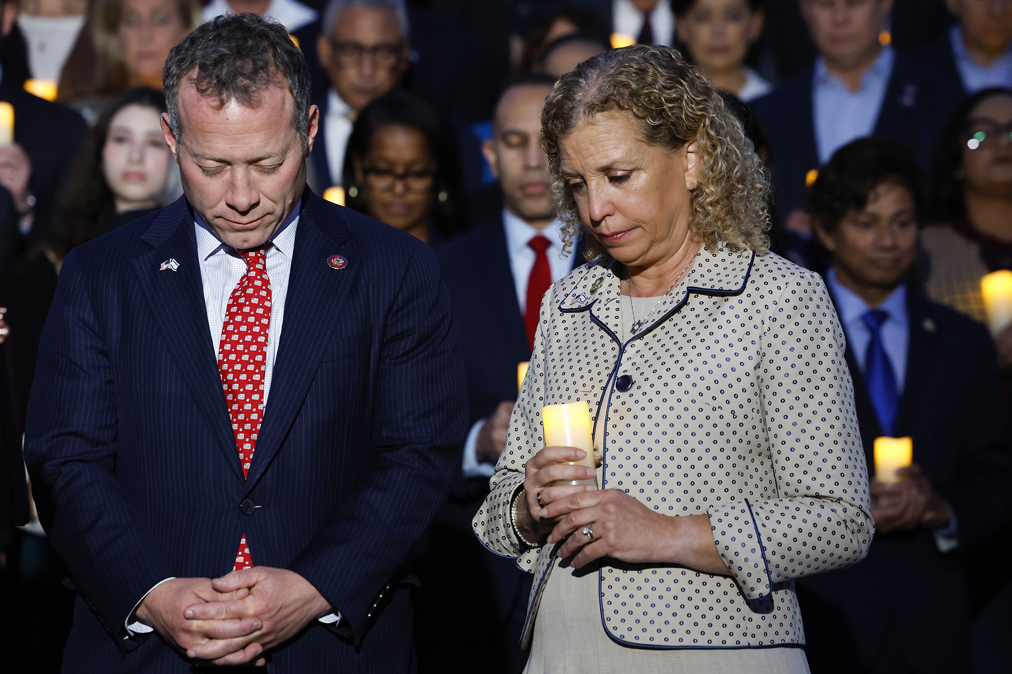 Josh Gottheimer and Rep. Debbie Wasserman Schultz bow their heads during a vigil for Israel on the steps of the U.S. Capitol Building on October 12, 2023 in Washington, DC.