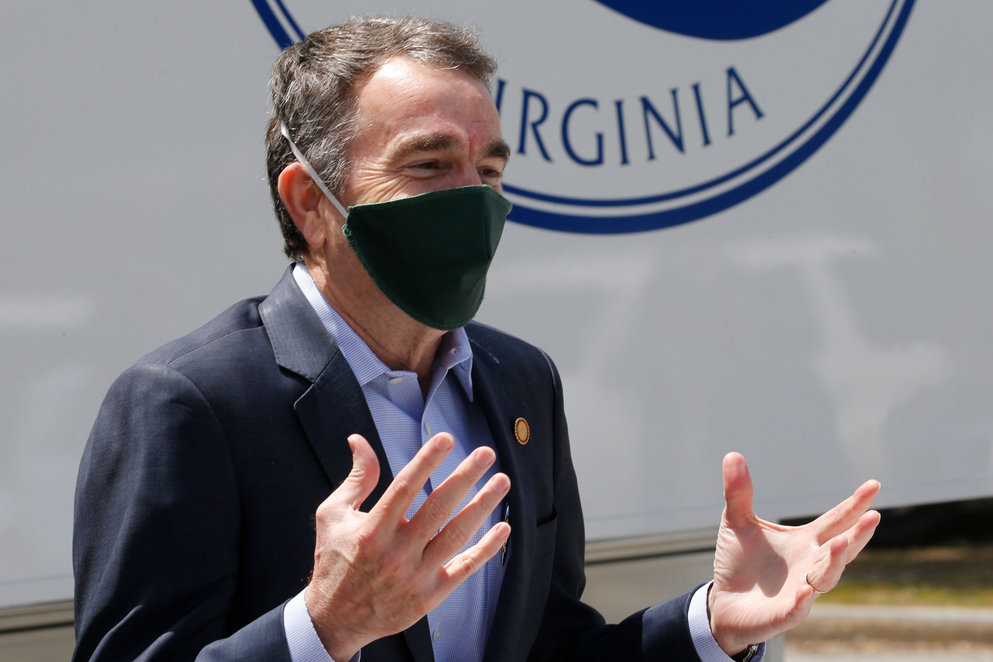 Virginia Gov. Ralph Northam gestures as he speaks to a group of volunteers to distribute supplies at health equity community event on May 12 in Richmond, Virginia.
