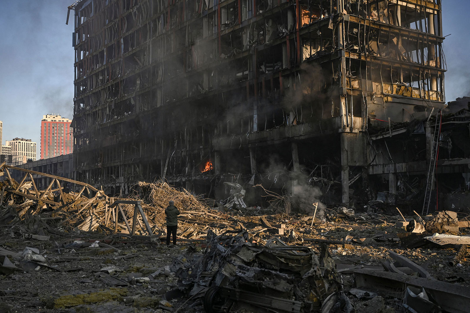 A man looks at a shopping mall following an explosion in Kyiv on March 21.