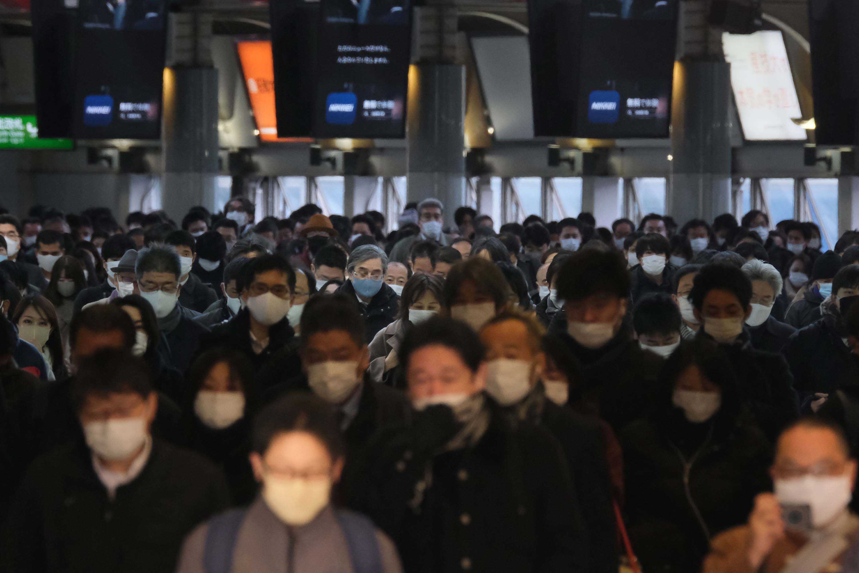 Commuters wear face masks as they make their way through Shinagawa Station in Tokyo, Japan, on January 8.