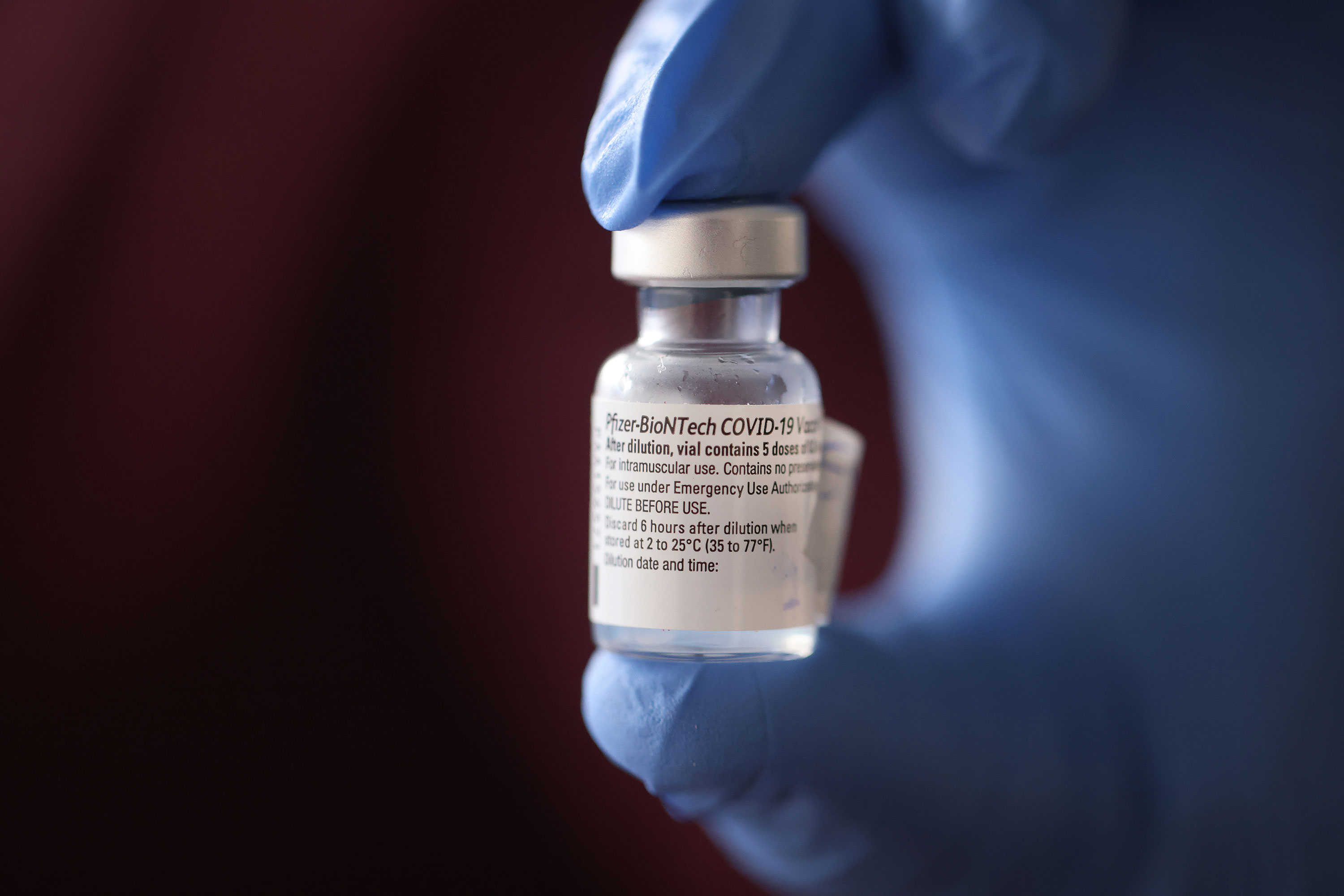 A nurse holds a vial of Pfizer's Covid-19 vaccine in Chicago on December 17.