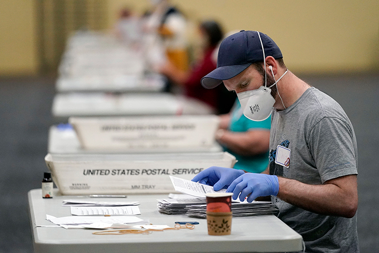 Workers prepare mail-in ballots for counting, Wednesday, November 4, at the convention center in Lancaster, Pennsylvania.