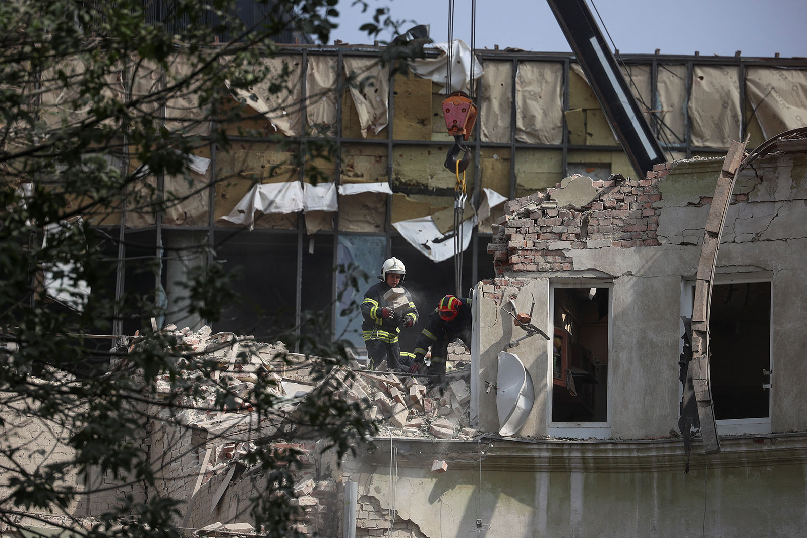 Rescuers work at a site of a residential building hit by a Russian missile strike in Lviv, Ukraine on Thursday, July 6.