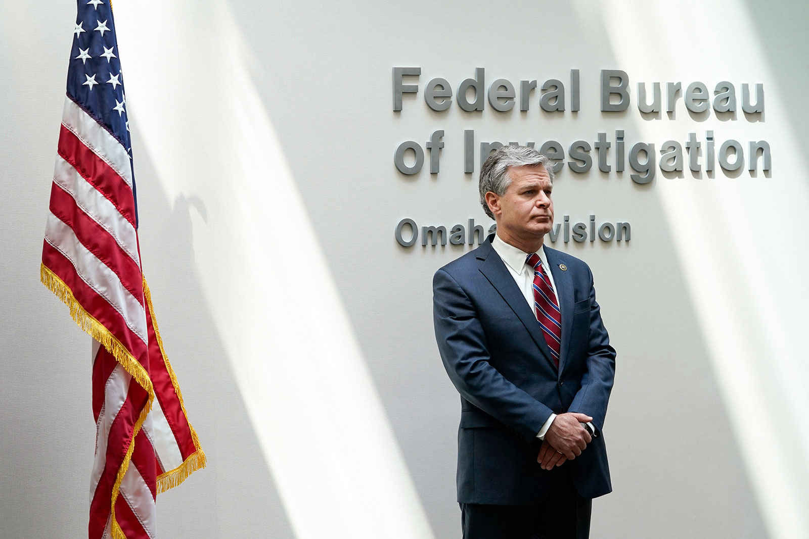 FBI Director Christopher Wray waits to speak at a news conference in Omaha, Nebraska, on August 10. 