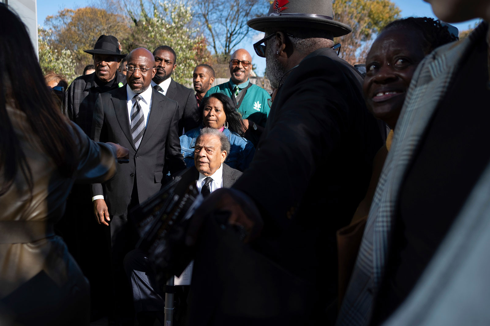 Sen. Raphael Warnock is accompanied by civil rights leader Andrew Young as they head to the polls in Atlanta on Sunday, November 27. 