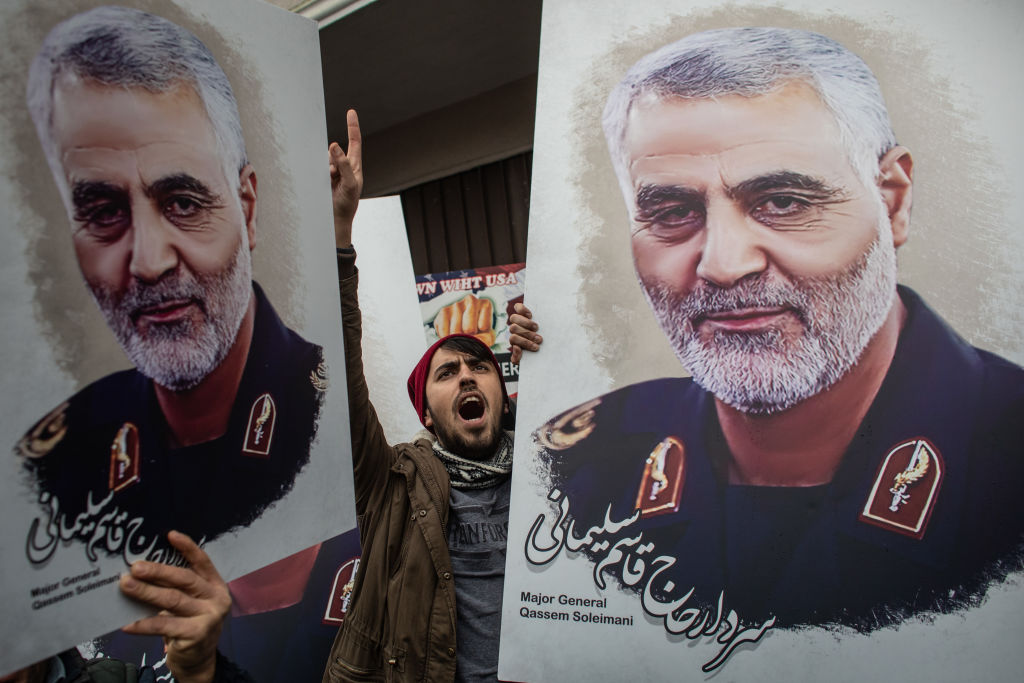 People hold posters showing the portrait of Iranian Revolutionary Guard Major General Qasem Soleimani and chant slogans during a protest outside the US Consulate on Jan. 5 in Istanbul, Turkey.