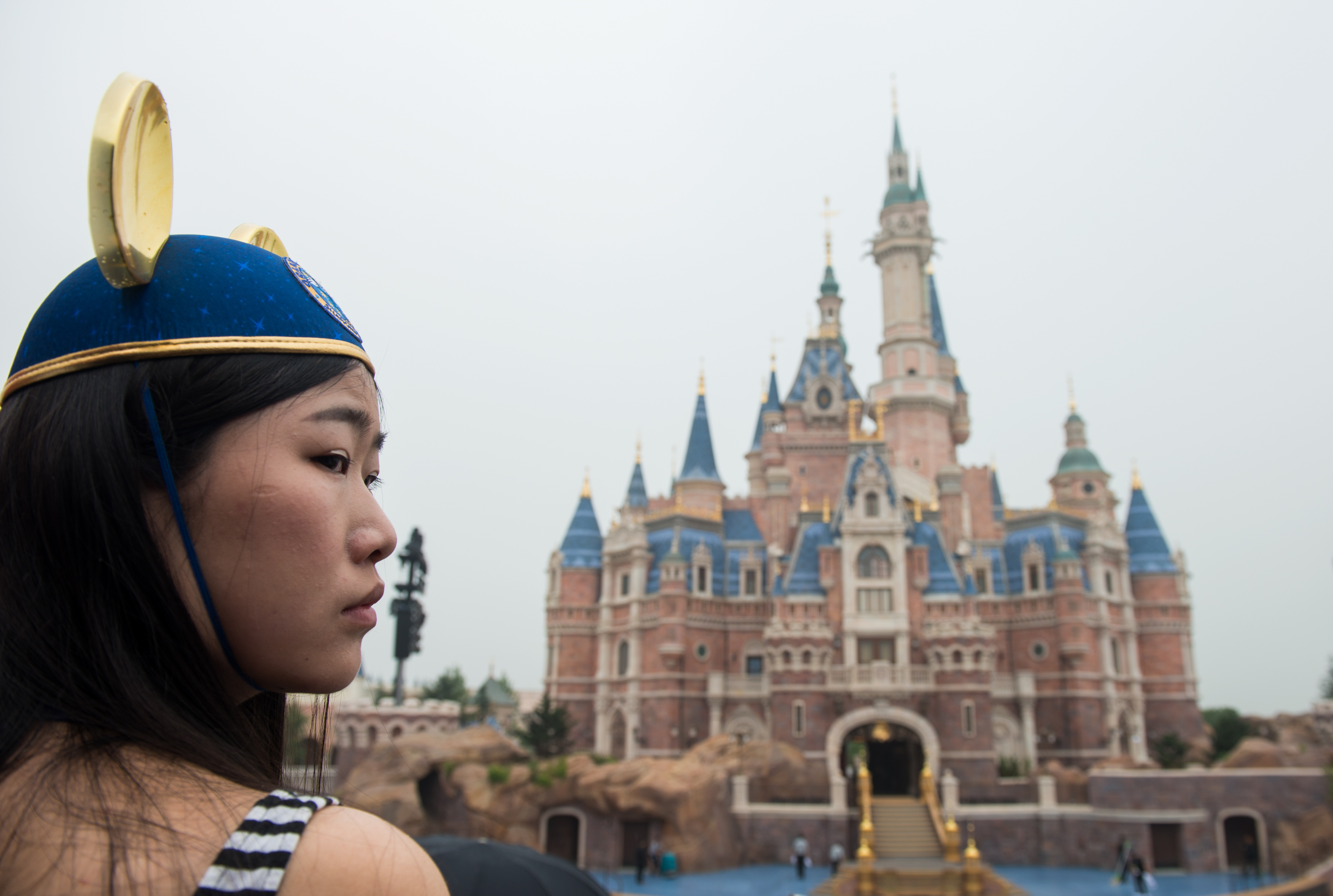A visitor wearing Mickey Mouse ears at the Shanghai Disney Resort on June 16, 2016.