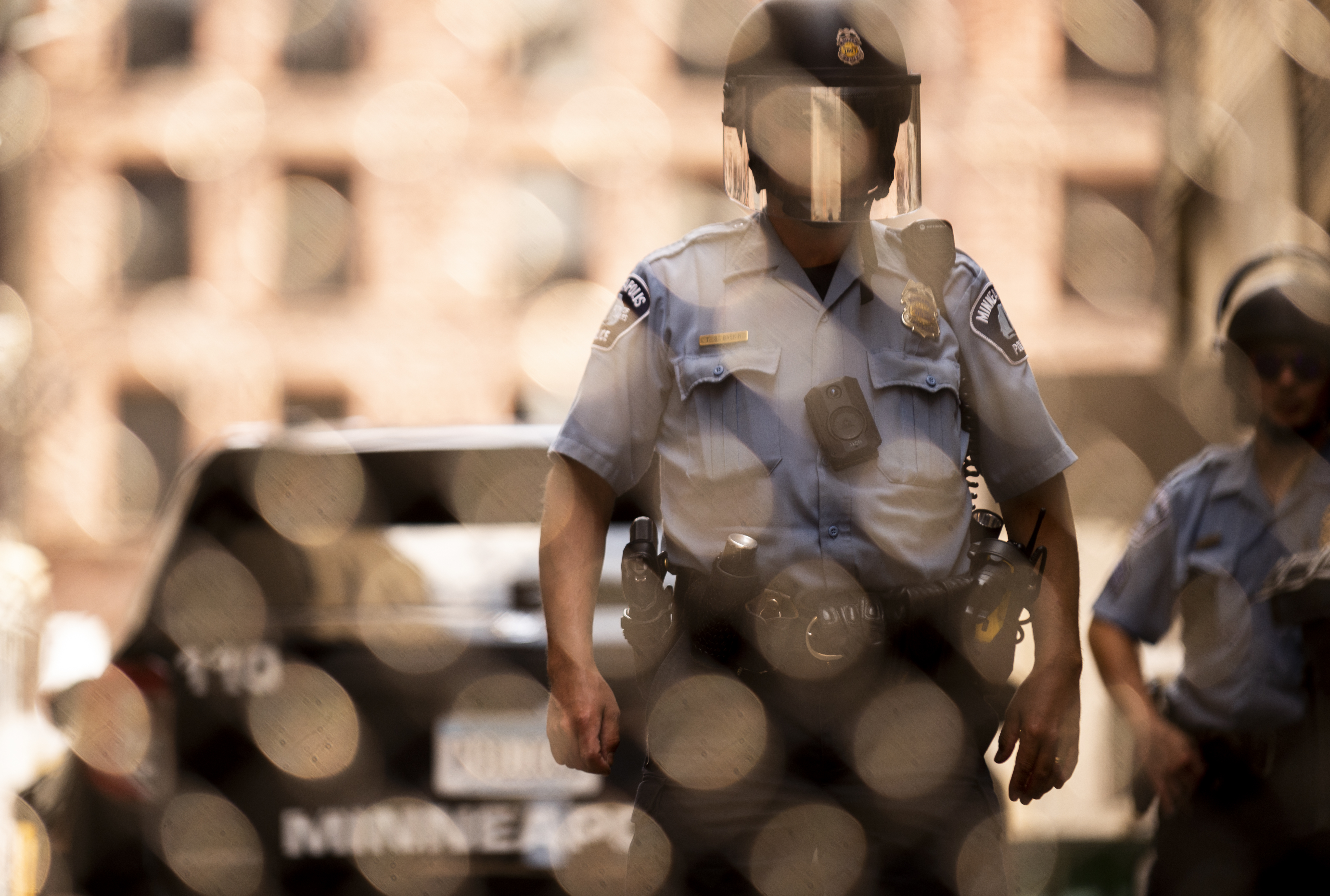 Members of the Minneapolis Police Department seen through a chain link gate on June 13, in Minneapolis, Minnesota.