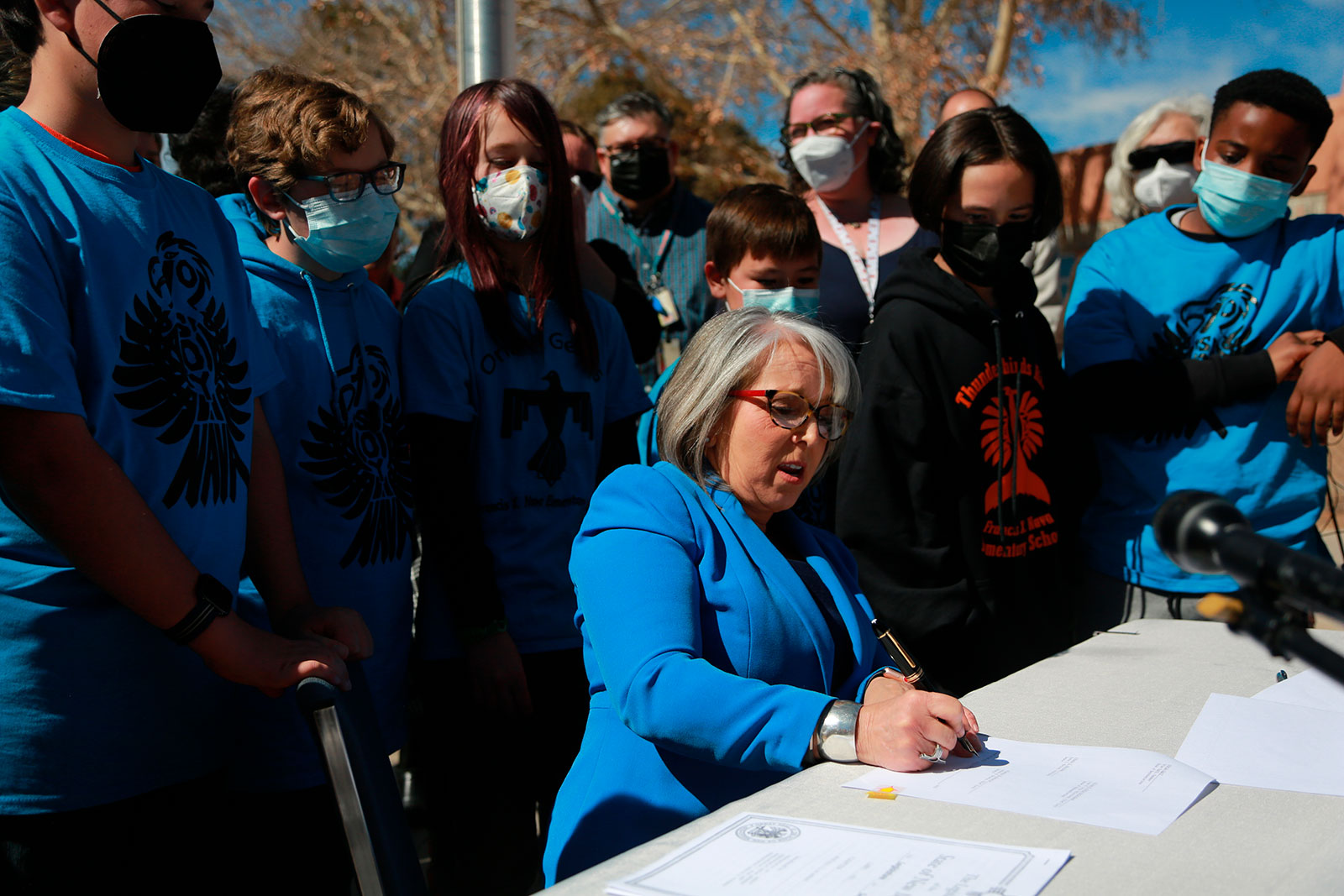 New Mexico Gov. Michelle Lujan Grisham signs an education bill on March 1 in Santa Fe, New Mexico.