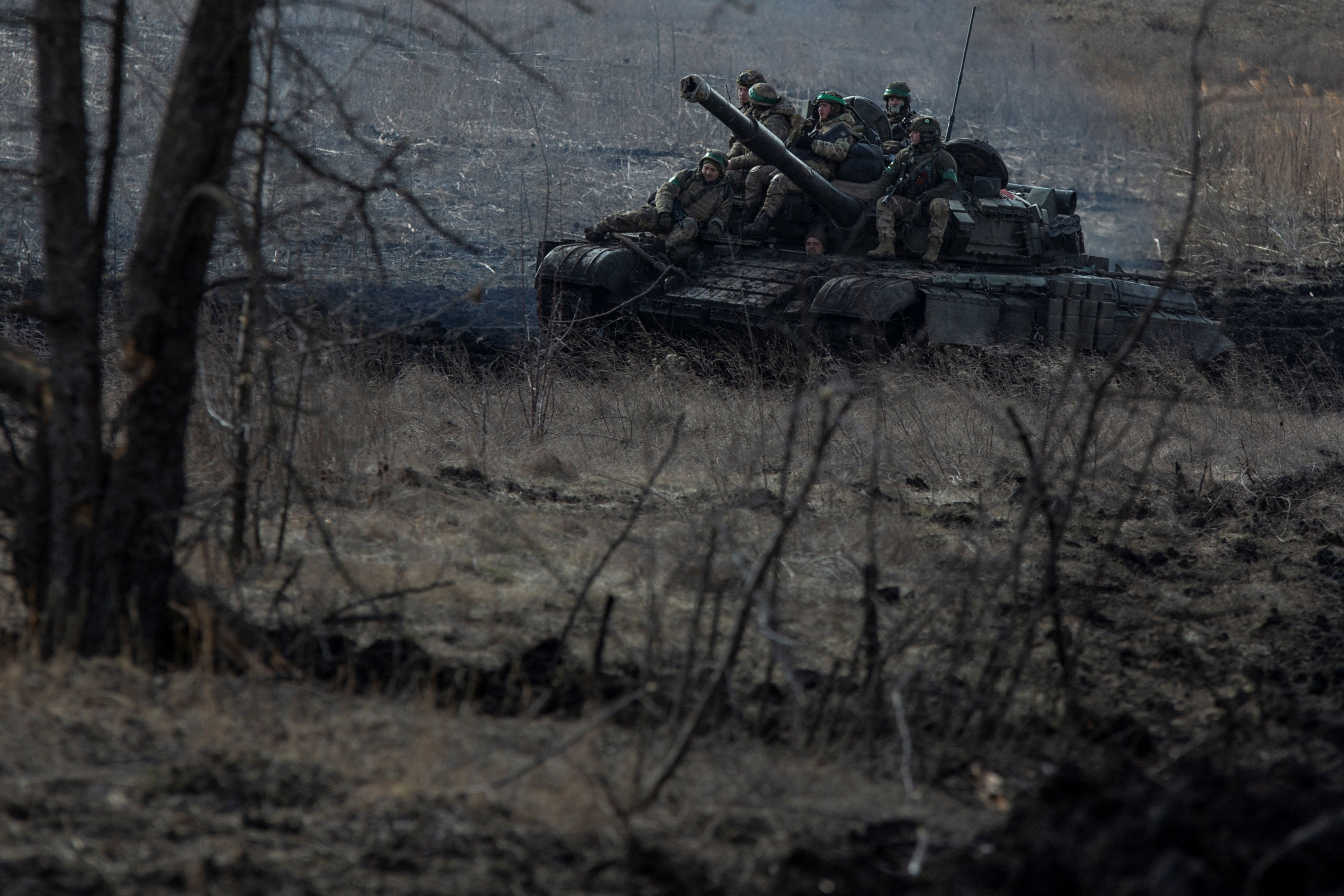 Ukrainian service members ride atop a tank near Bakhmut on March 4. 