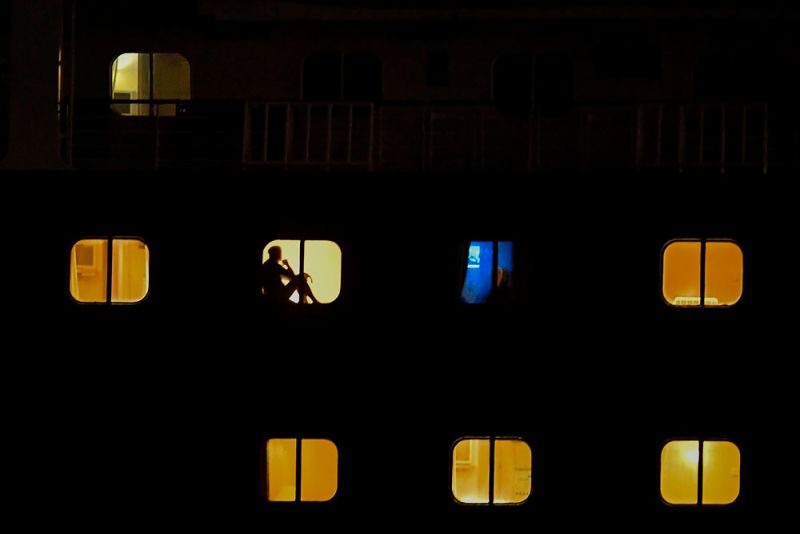 Passengers of Holland America's cruise ship Zaandam are seen as the ship navigates through the Panama Canal in Panama City, on March 29.