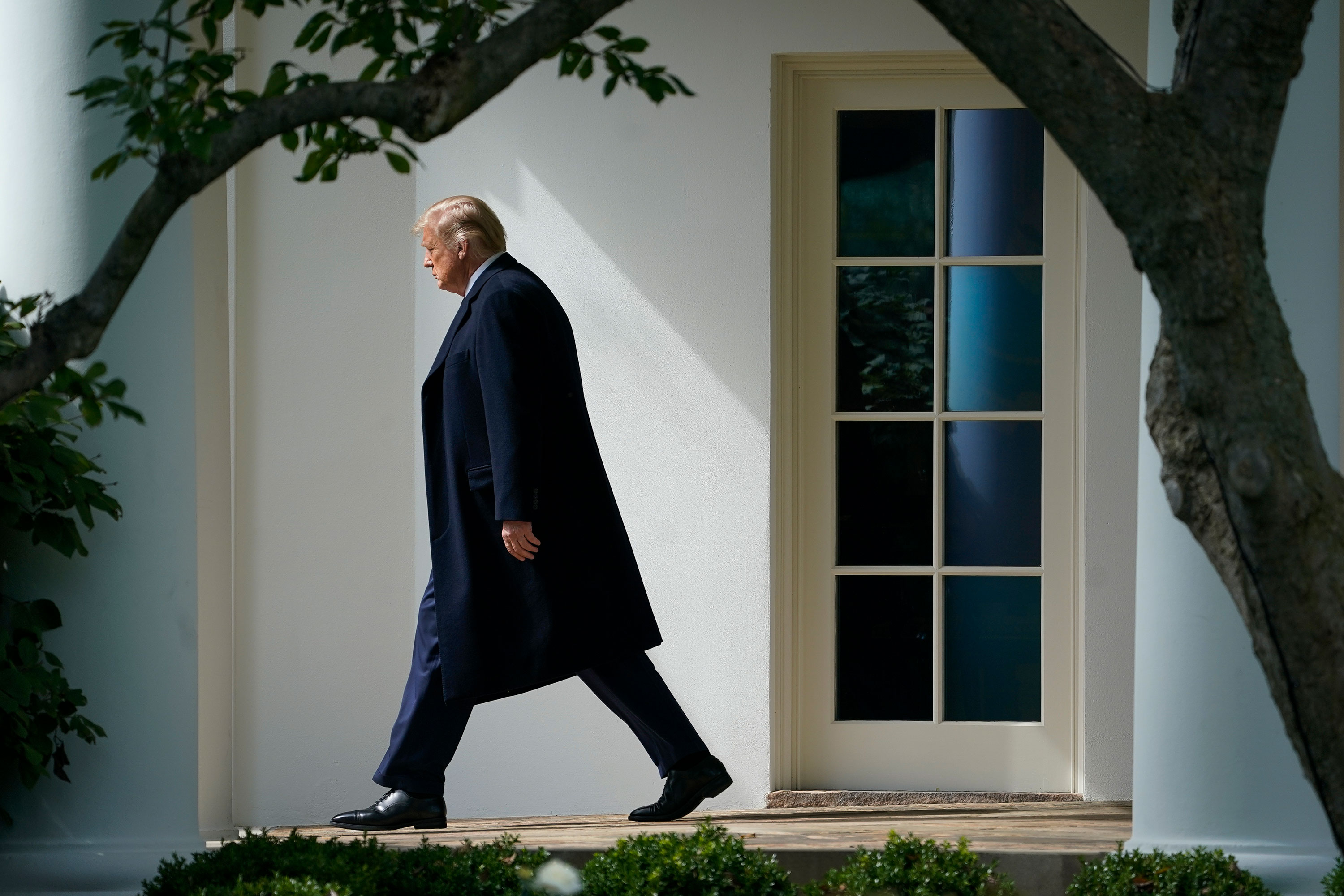 President Donald Trump exits the Oval Office and walks to Marine One on the South Lawn of the White House on October 1. President Trump was traveling to Bedminster, New Jersey, for a roundtable event with supporters and a fundraiser.