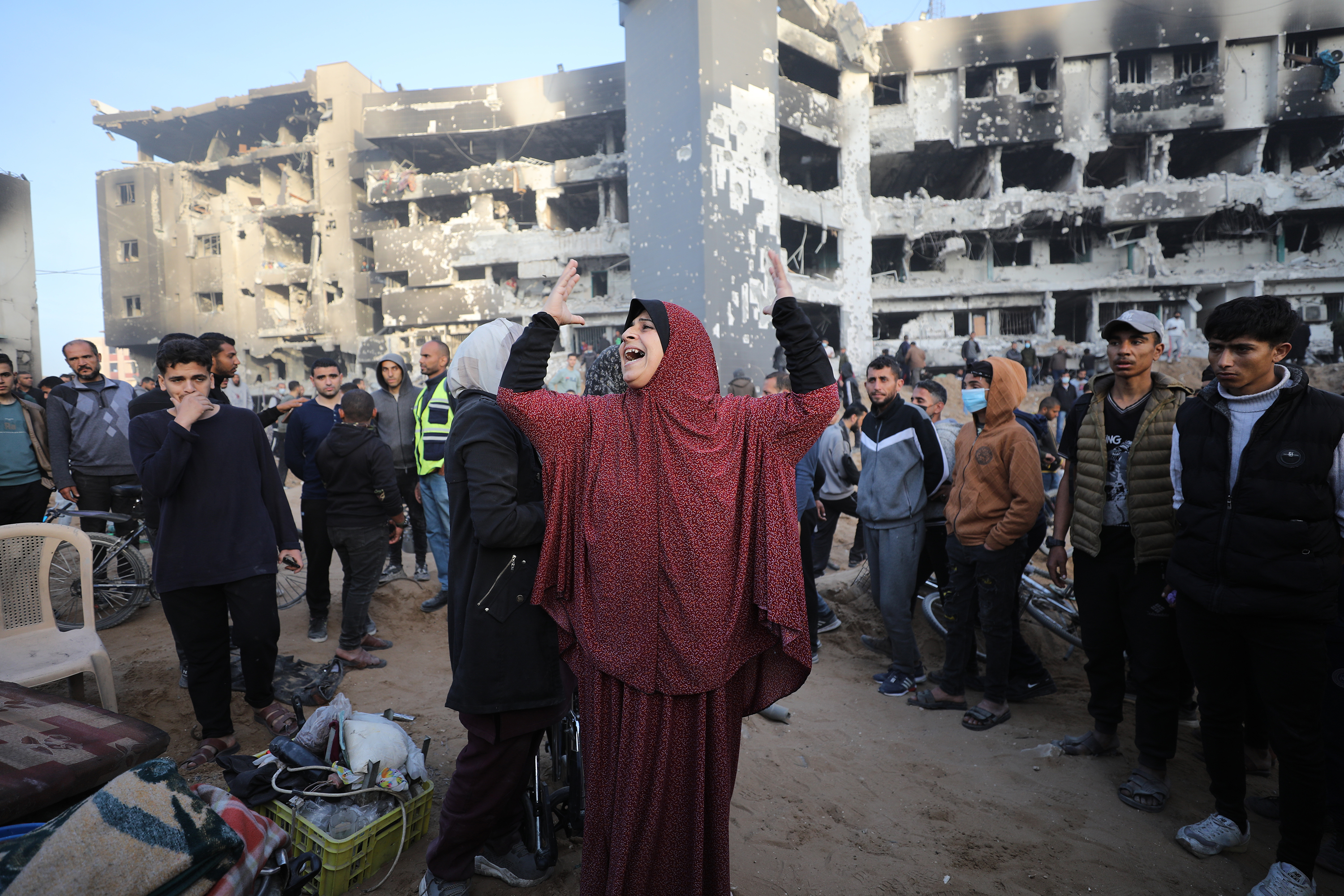 A woman mourns around destroyed Al-Shifa Hospital.
