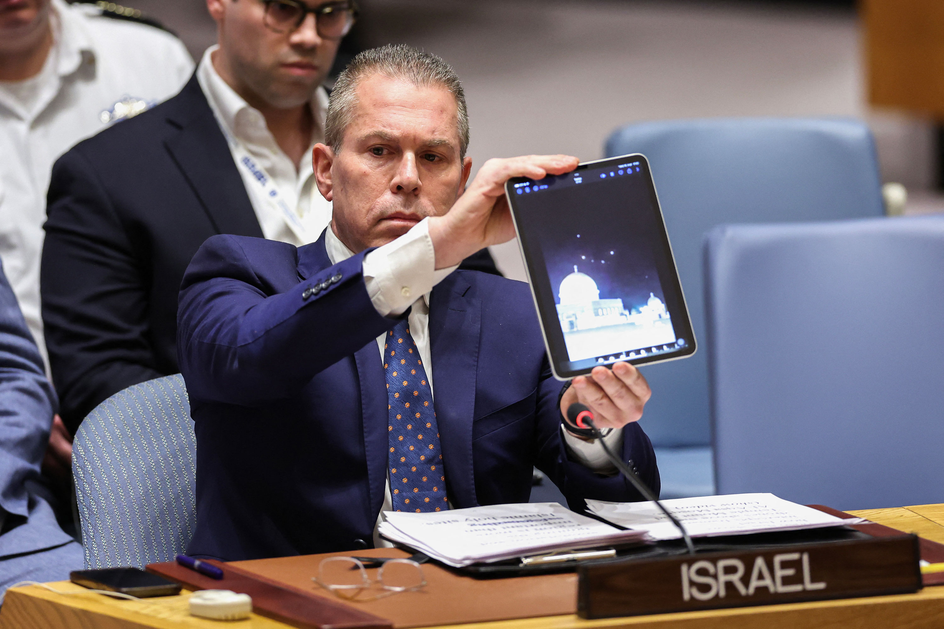 Israel’s UN ambassador Gilad Erdan shows a video of drones and missiles heading toward Israel during a United Nations Security Council meeting at UN headquarters in New York on Sunday. 