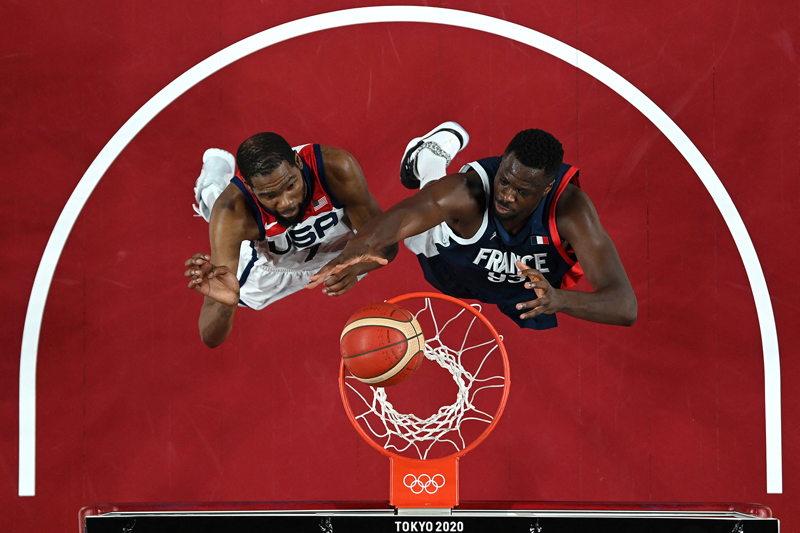 United States' Kevin Durant and France's Moustapha Fall battle in the men's basketball final on August 7.