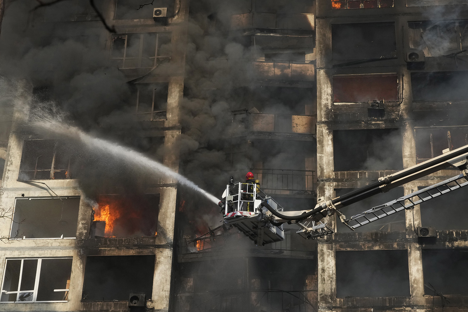 Firefighters work in an apartment building damaged by shelling in Kyiv, Ukraine, on March 15.