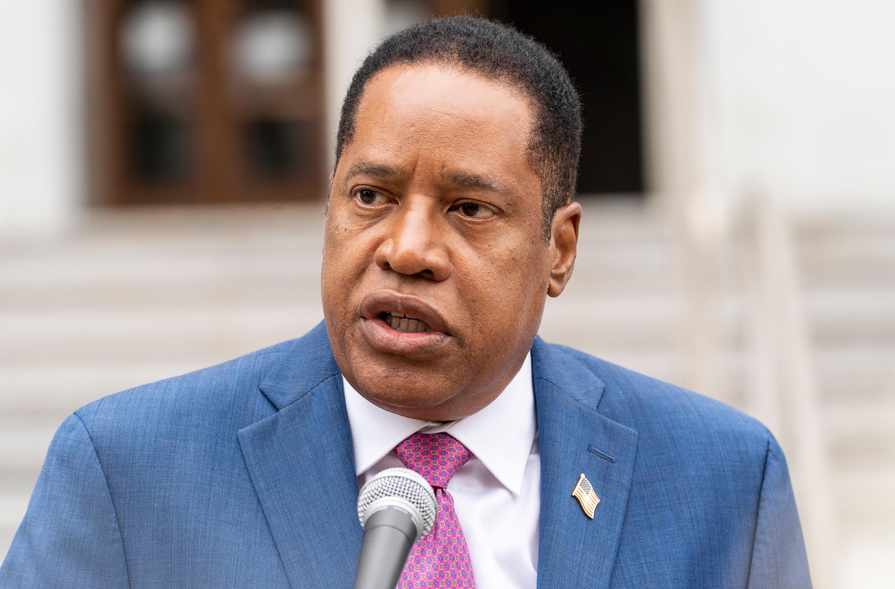 Larry Elder takes questions from the media during a campaign stop outside the Hall of Justice downtown Los Angeles Thursday, September 2, 2021. 