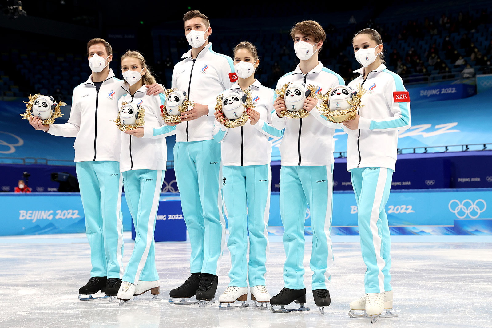 The ROC team poses during the flower ceremony for the figure skating team event on February 7. 