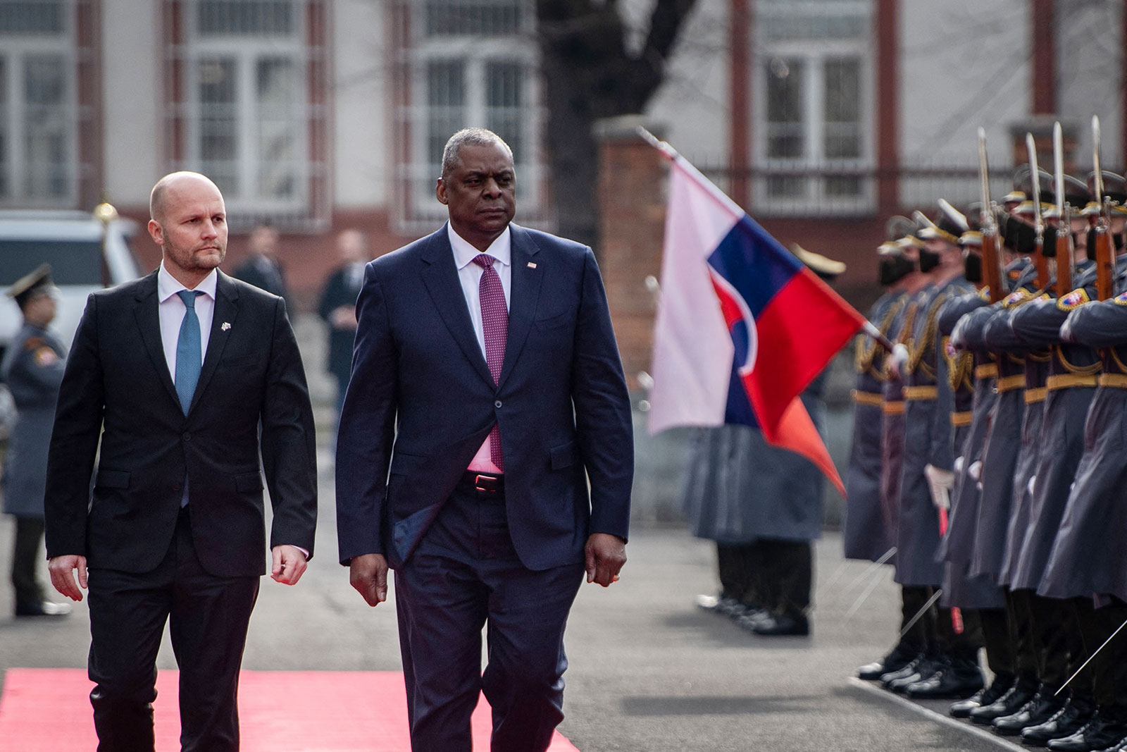 US Defense Secretary Lloyd Austin, right, and Slovakian Minister of Defence Jaroslav Nad' walk past a military honor guard in Bratislava on March 17. 
