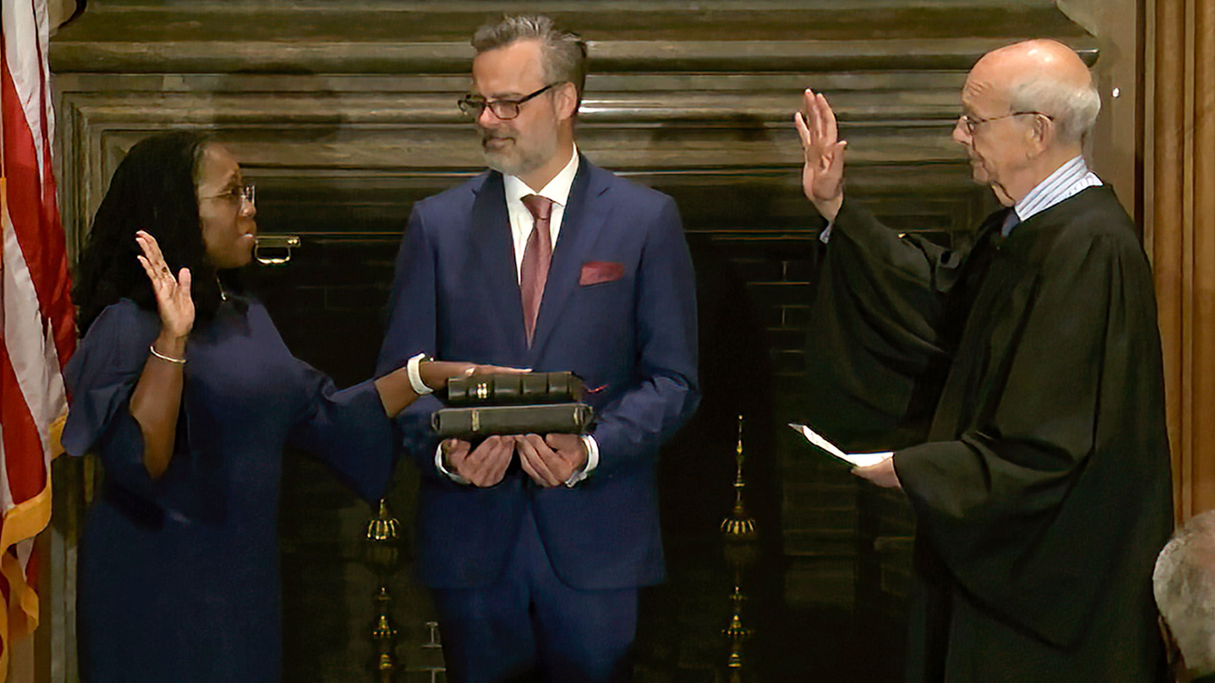 In this image from video provided by the Supreme Court, retired Supreme Court Justice Stephen Breyer administers the judicial oath to Ketanji Brown Jackson on Thursday. Her husband, Patrick, is holding the Bible next to her.