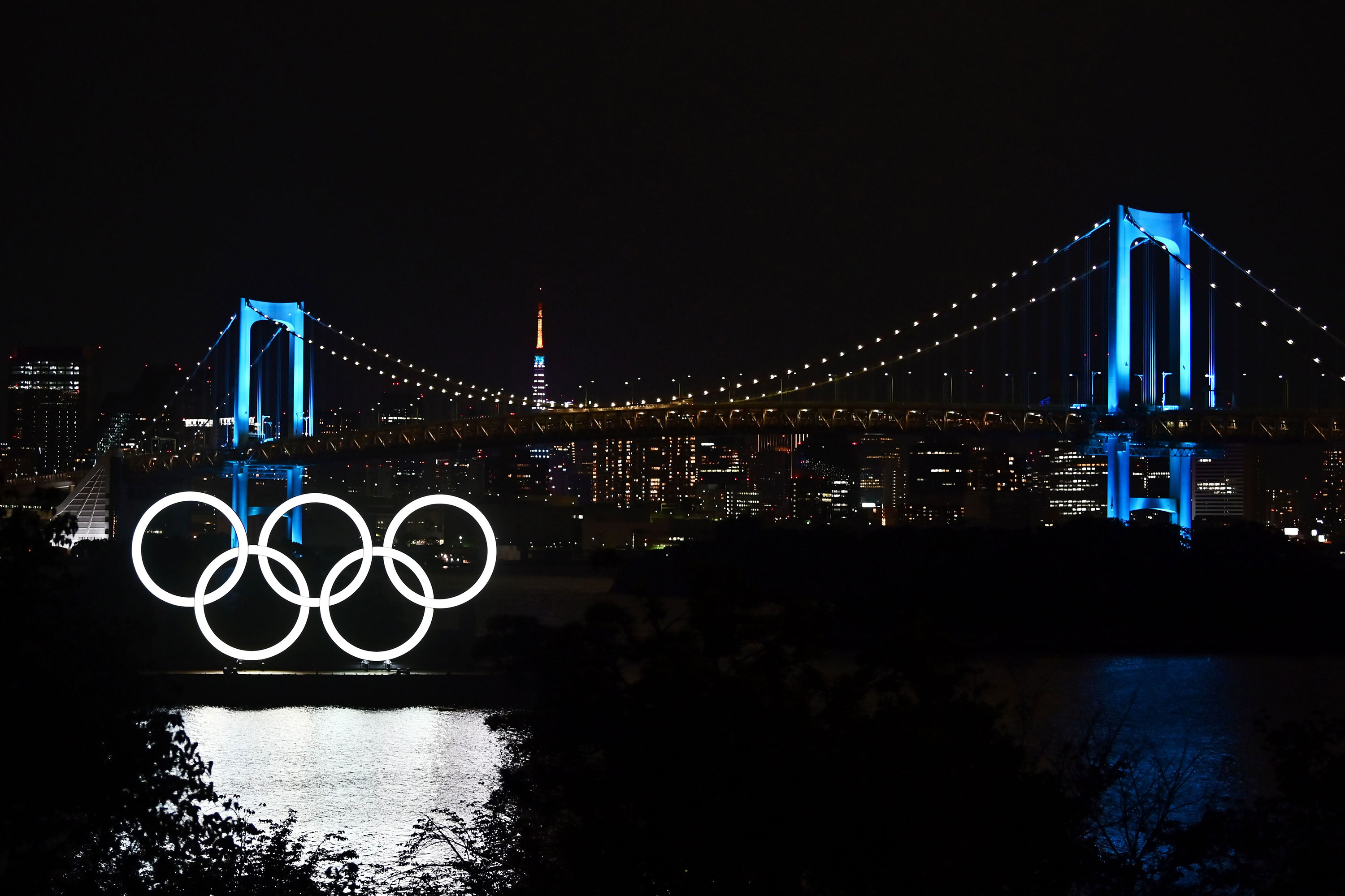 The Olympic rings, the Rainbow Bridge and the Tokyo Tower are seen at night in Tokyo on May 15.