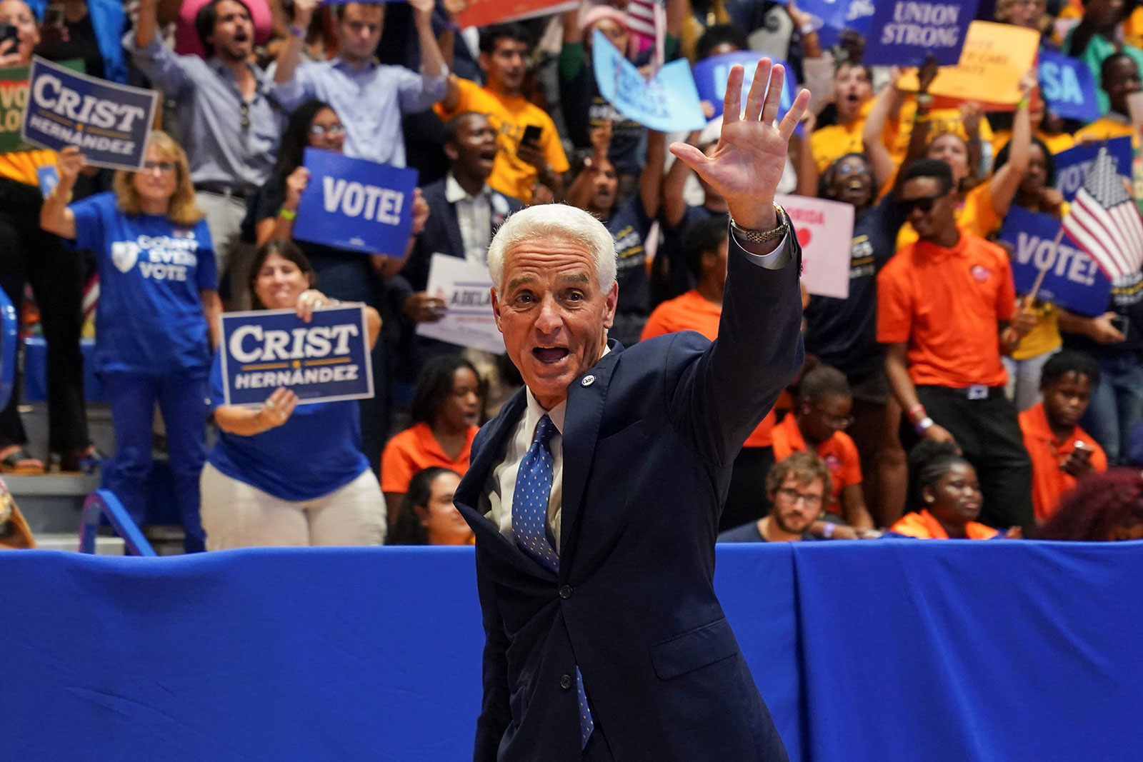 Charlie Crist waves while attending a campaign rally with President Joe Biden and Rep. Val Demings. 