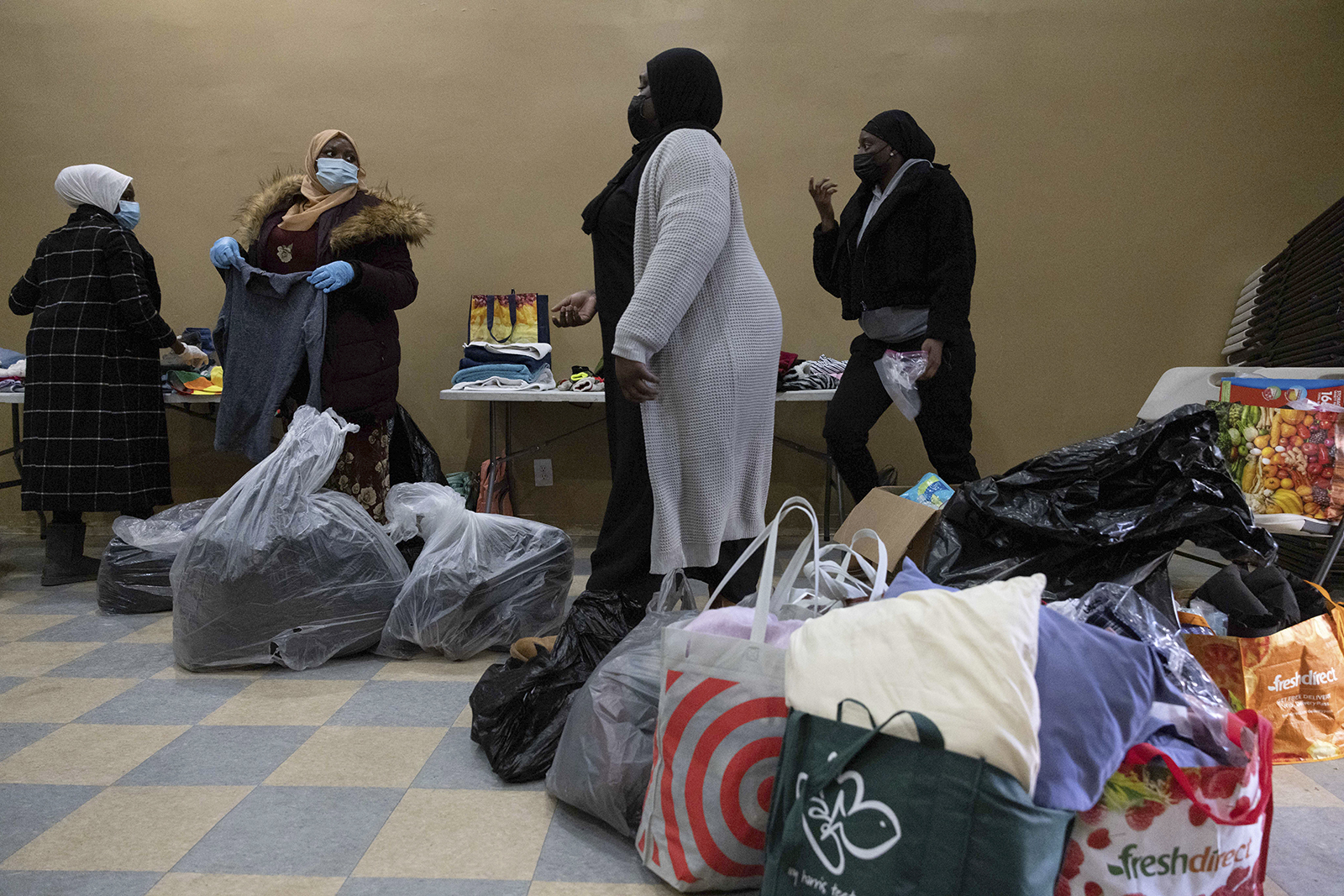 People prepares donations at Gambian Youth Organization near the apartment building where a deadly fire occurred in the Bronx, on Monday. 