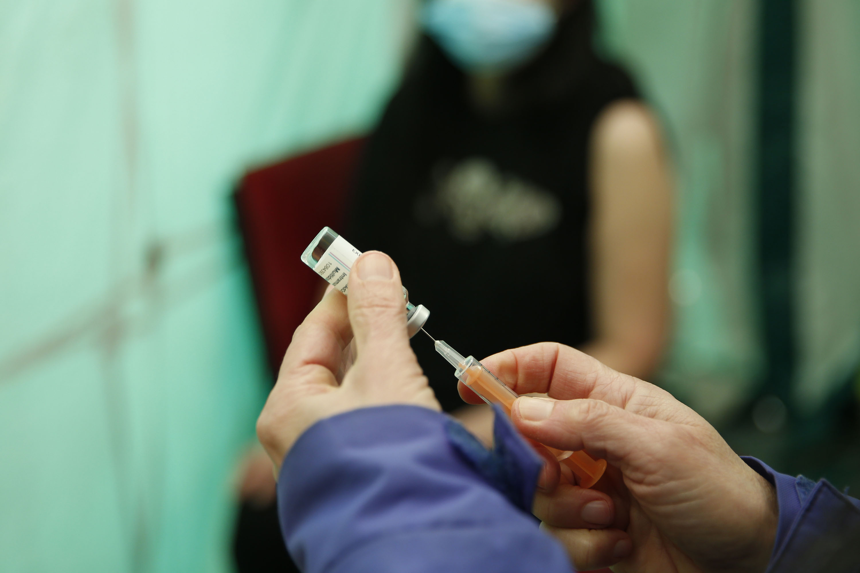 A doctor prepares a dose of the Oxford-Astra-Zeneca vaccine at a vaccination unit in London on February 28. 