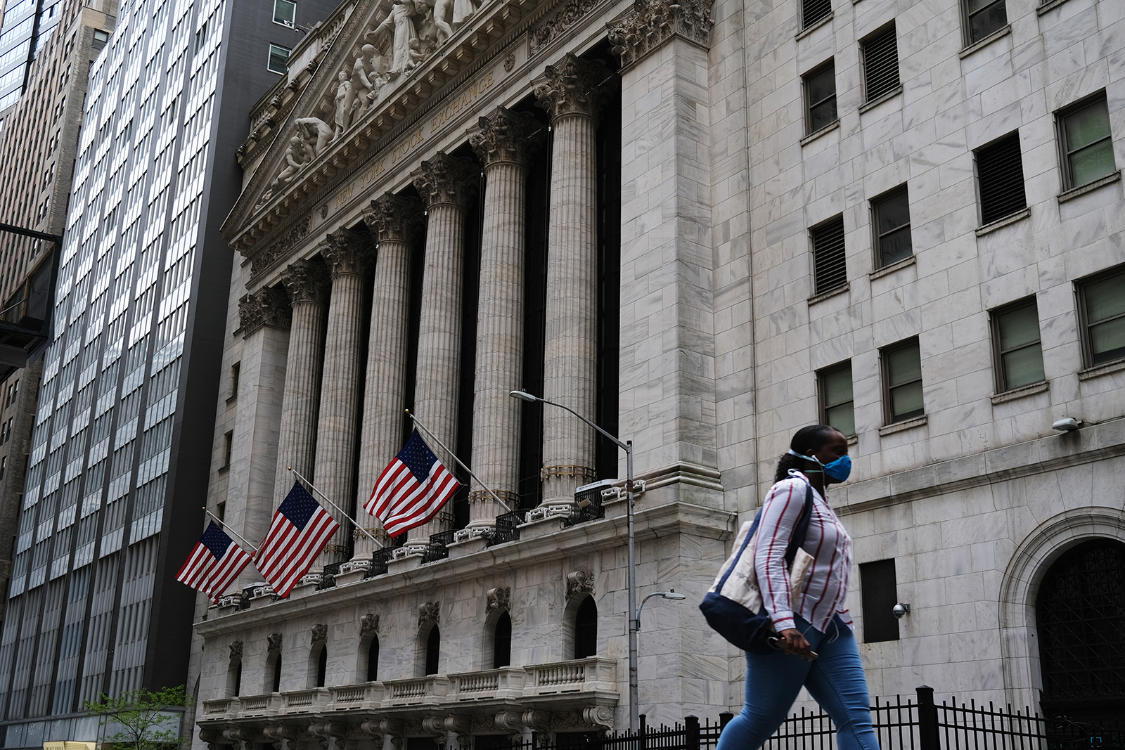 People walk by the New York Stock Exchange (NYSE) in New York City on May 18.