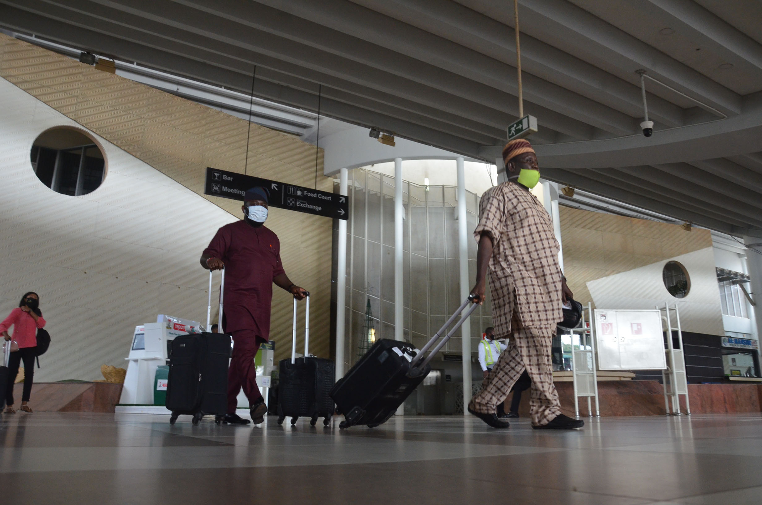 Passengers walk in the terminal building at the airport in Abuja, Nigeria, on July 8.