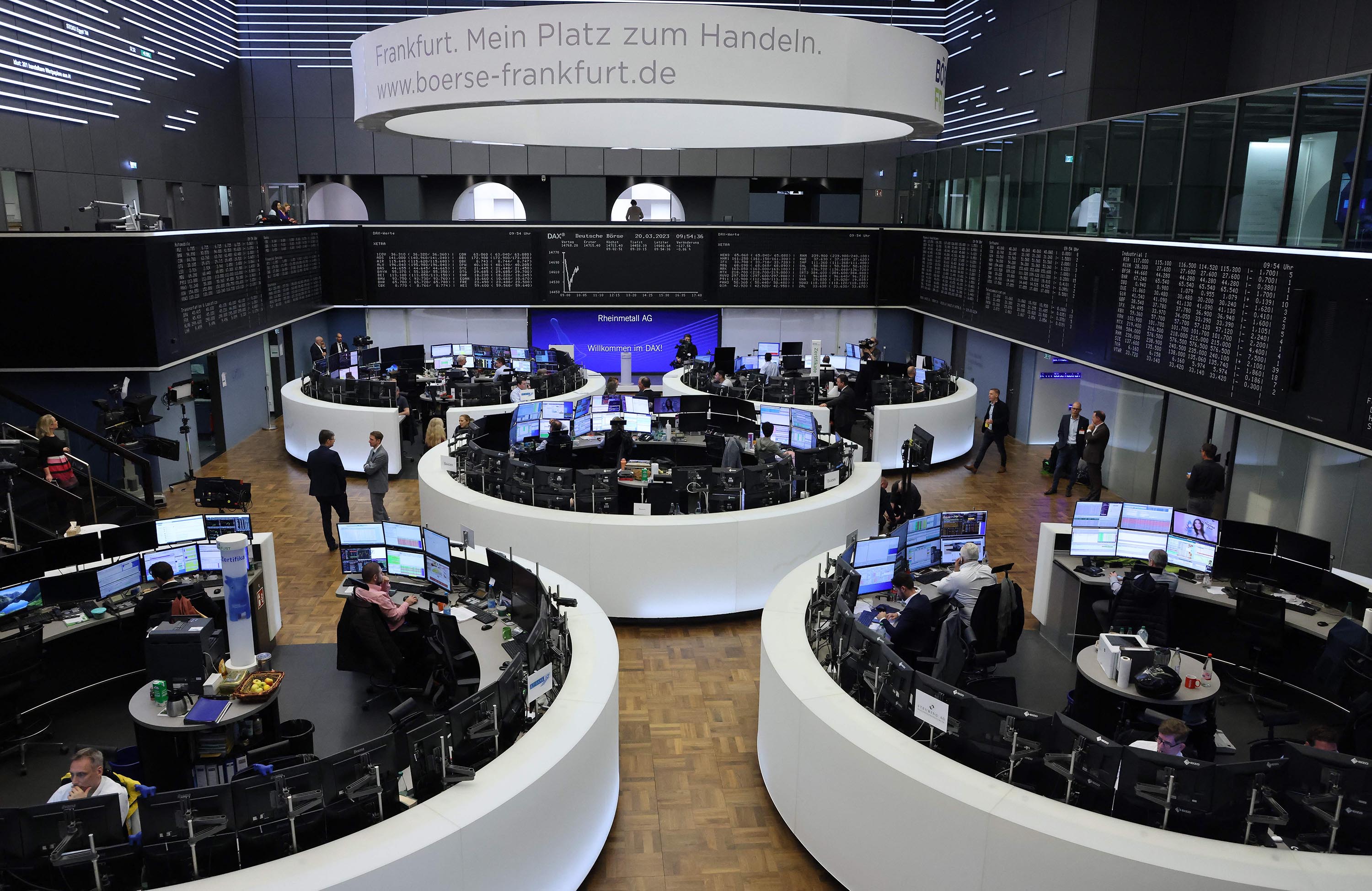 Traders work at the stock exchange in Frankfurt, Germany, on March 20. 